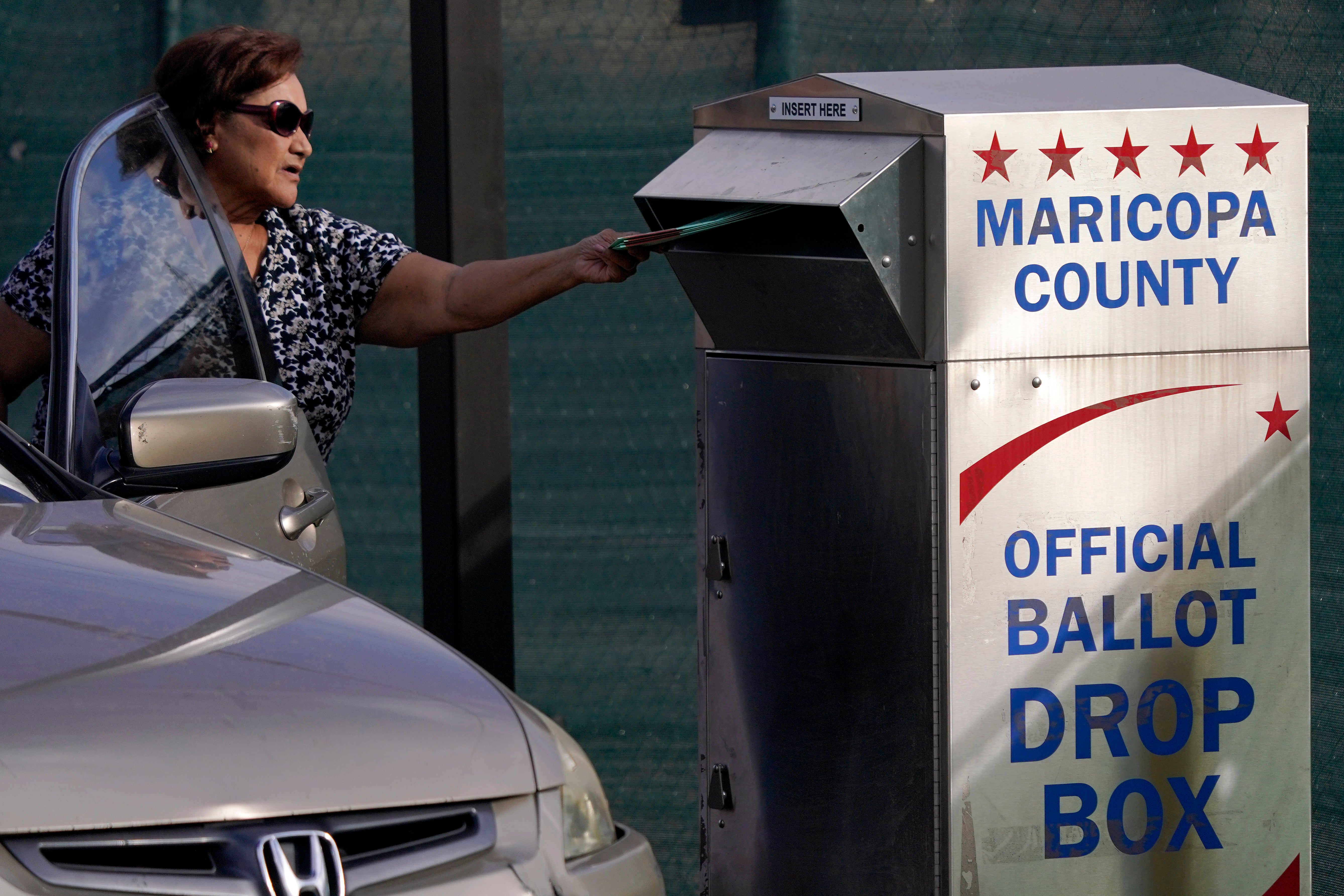 A voter casts their ballot at a secure ballot drop box at the Maricopa County Tabulation and Election Center in Phoenix, Arizona