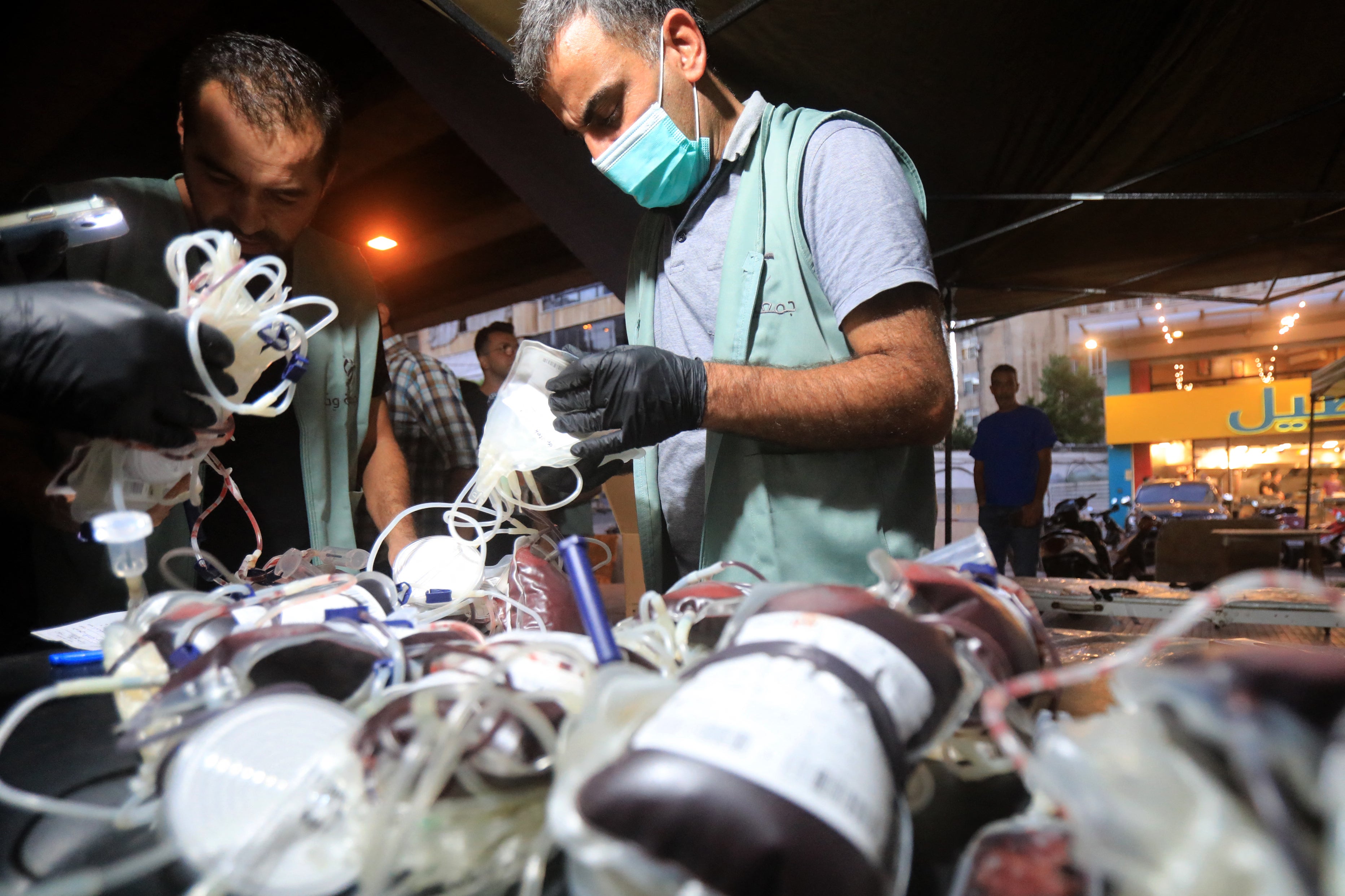 Medics collect blood donations in Beirut’s southern suburb after the explosions