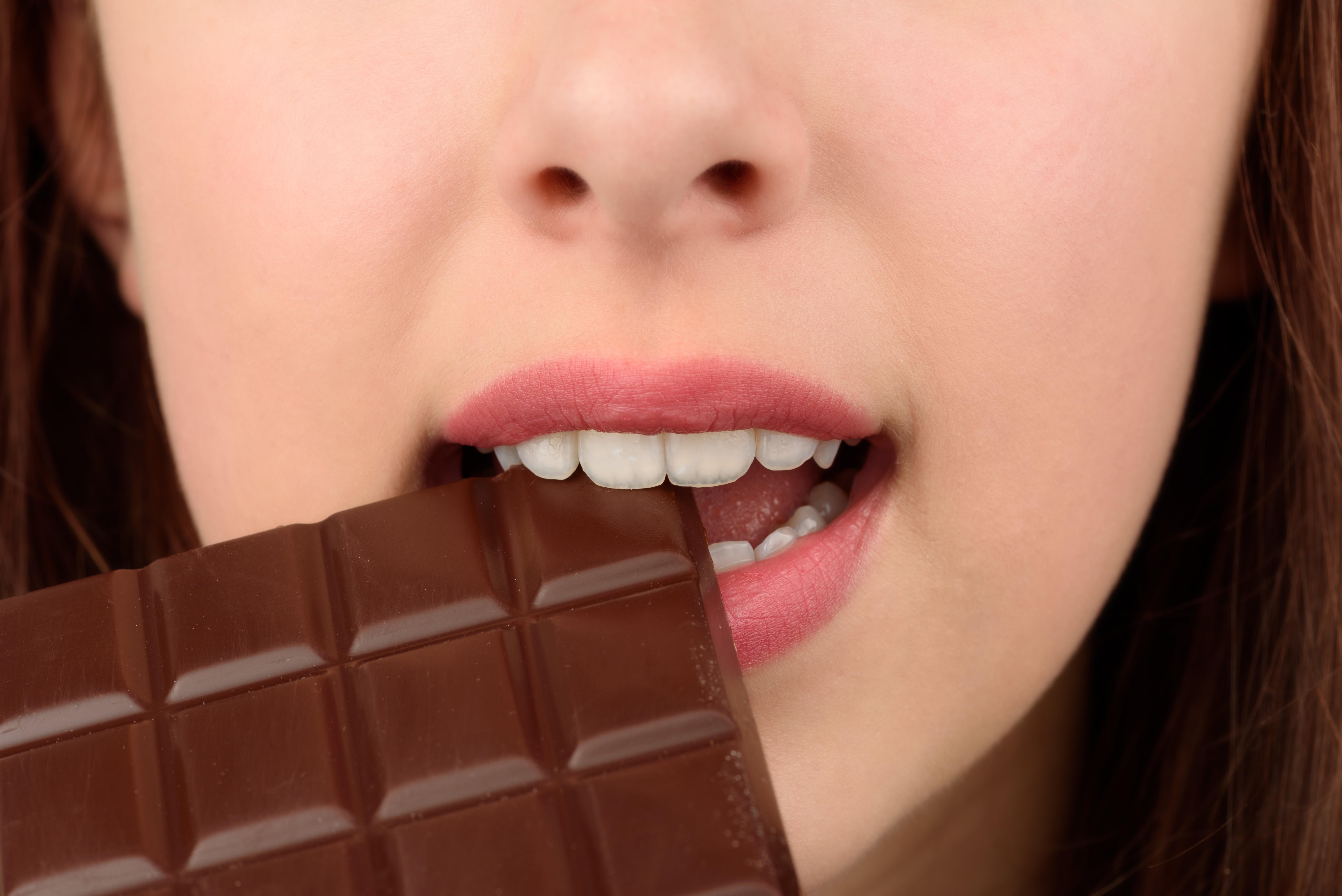 Close-up photo of woman eating chocolate (Alamy/PA)