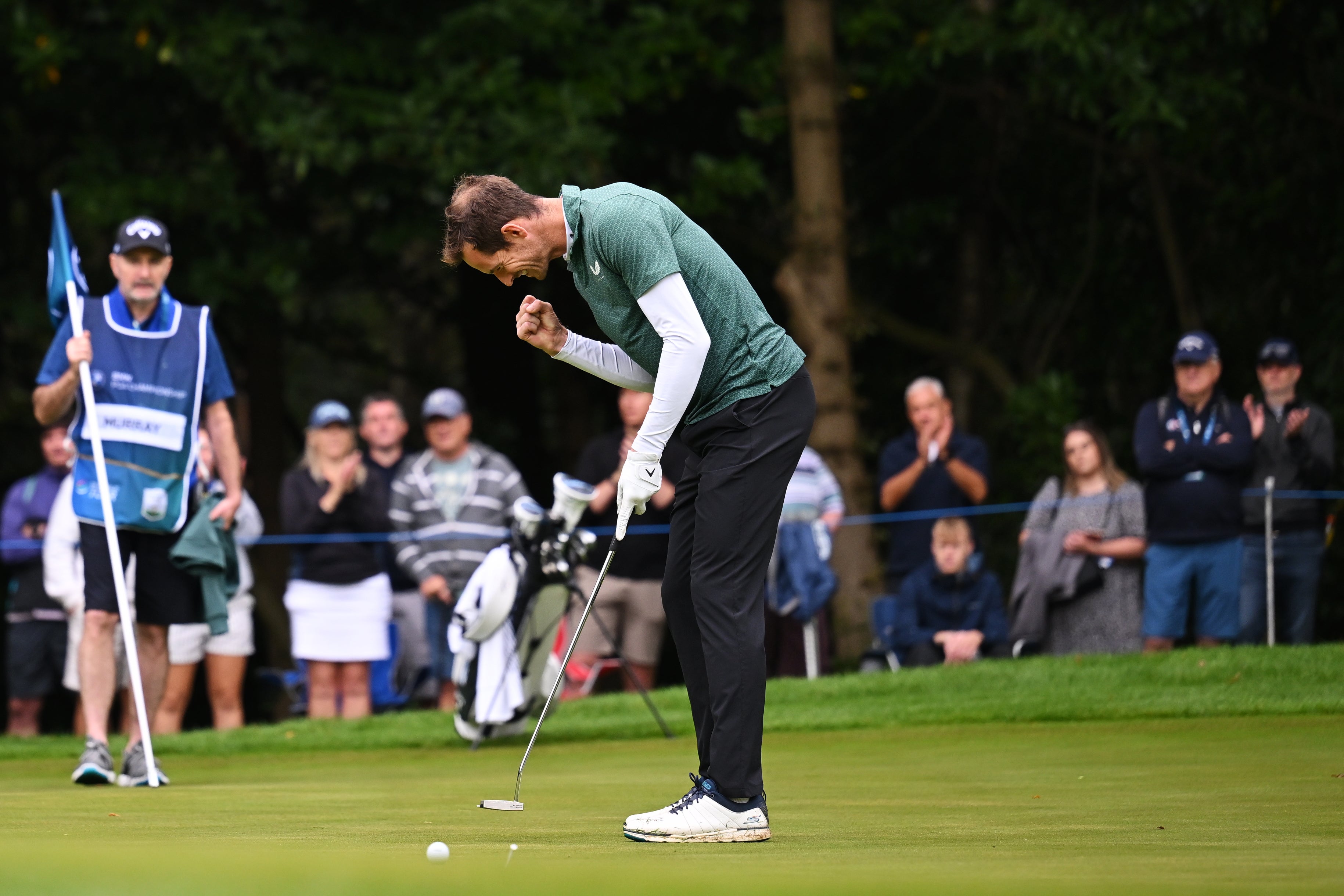 Andy Murray celebrates following putt on the first green