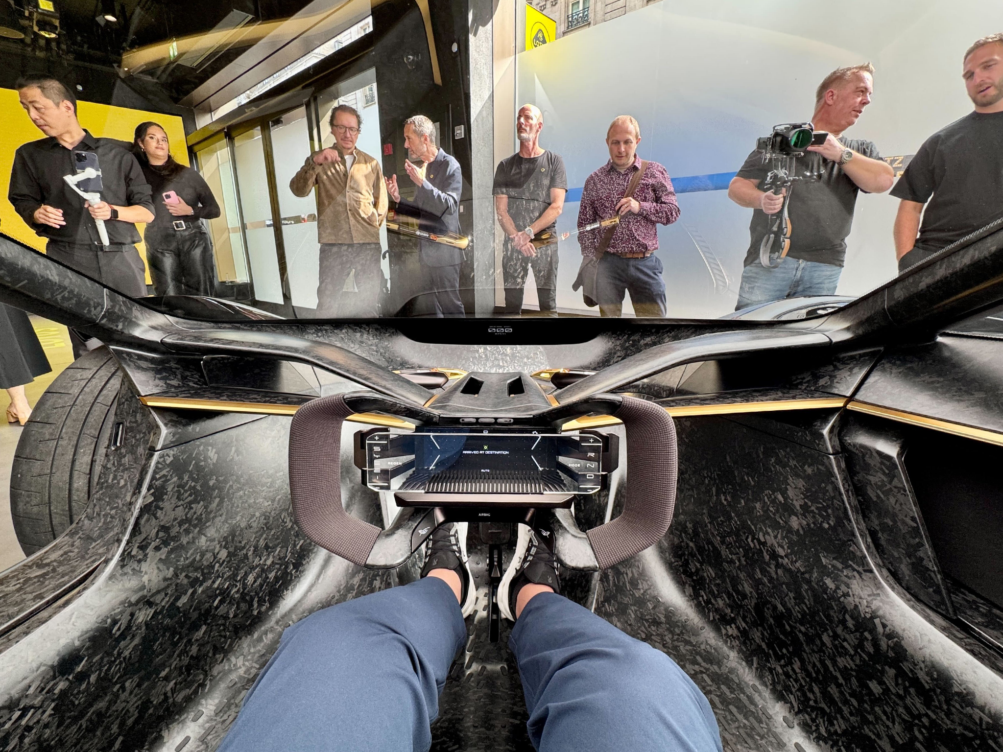 The Lotus Theory 1 concept car offers an IMAX-style view from the enormous windscreen, with the dashboard visible through a reflected HUD.