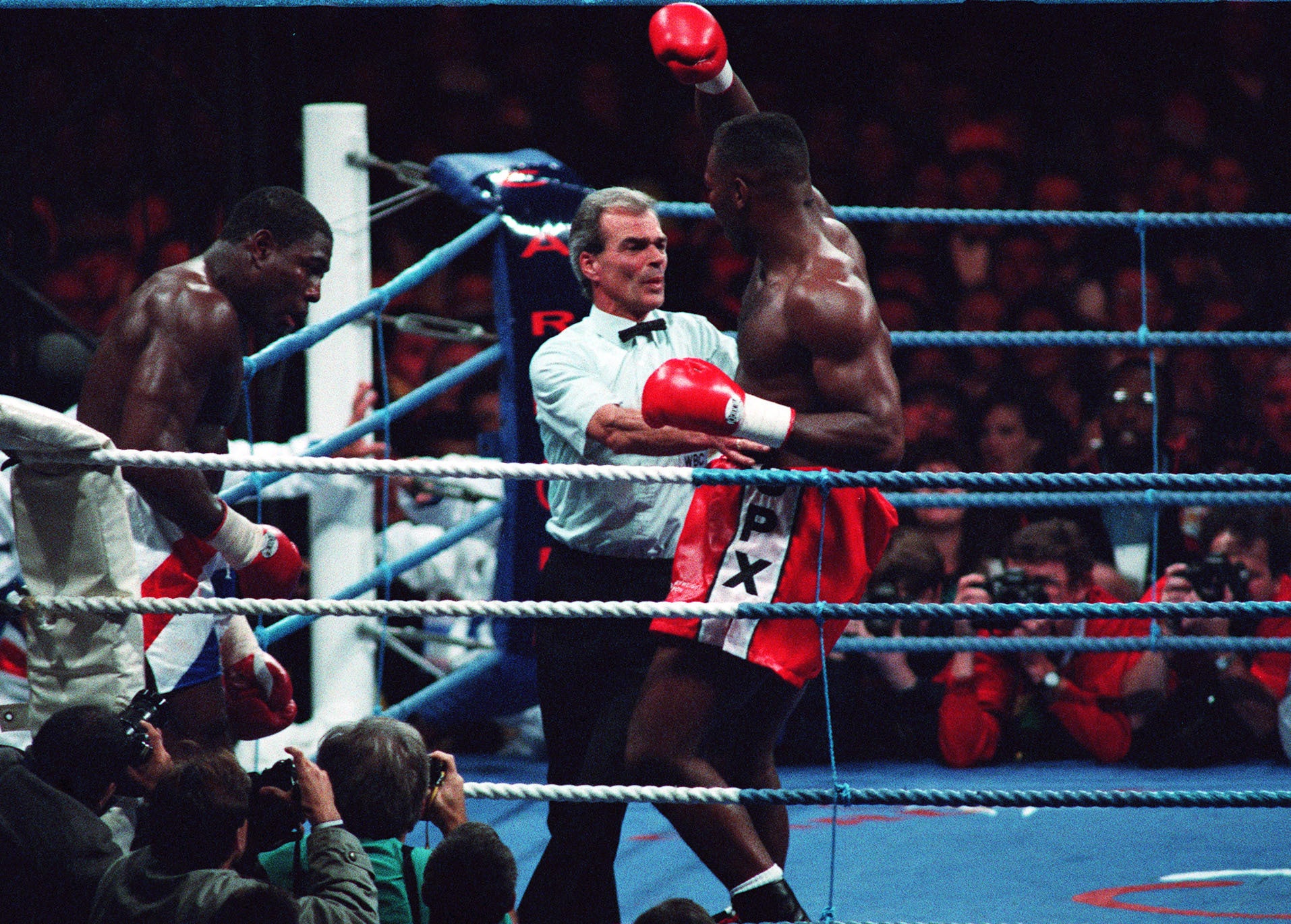 Frank Bruno slumps against the ropes as Lennox Lewis completes a seventh-round stoppage win in 1993 (David Jones/PA)