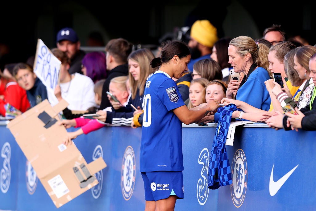 Chelsea’s Sam Kerr signs a shirt following a WSL match