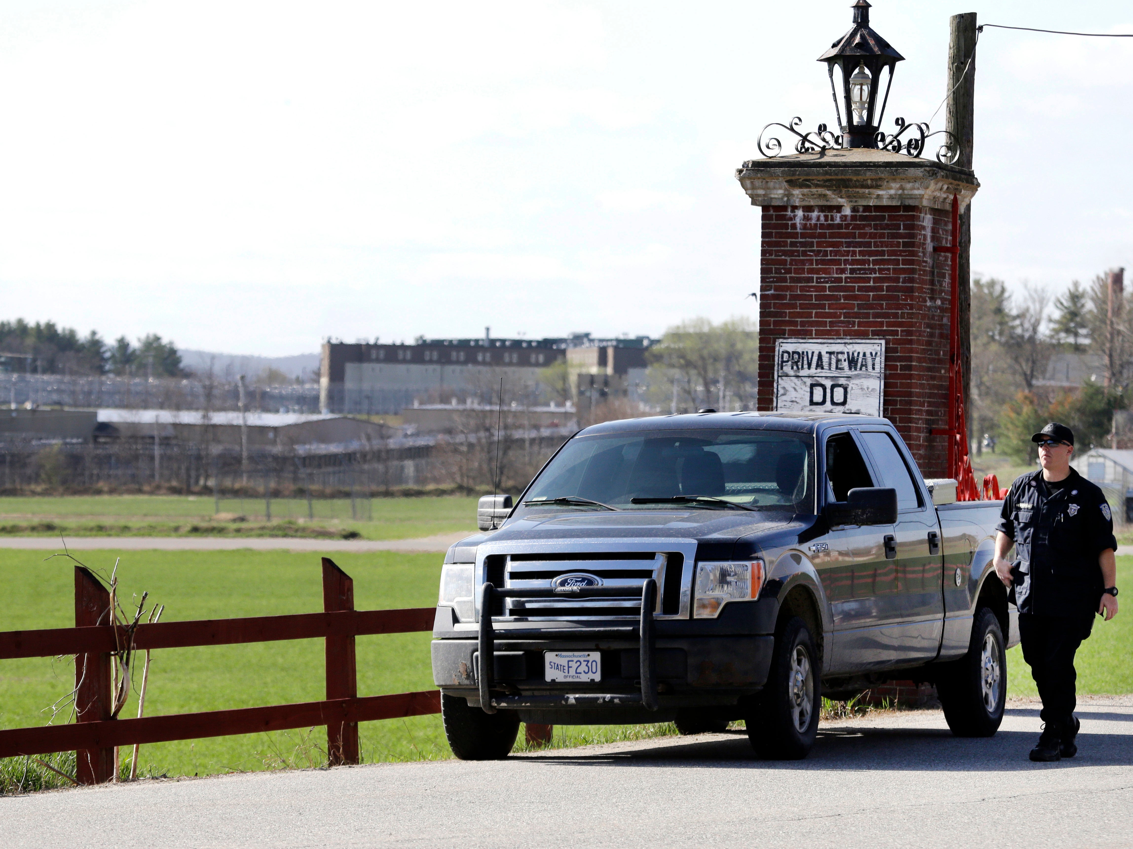 A police officer guards an entrance to the Souza-Baranowski Correctional Center on April 19, 2017, in Shirley, Massachusetts. Five guards at the facility were injured on September 18 when a group of inmates assaulted them, stabbing two and assaulting three others