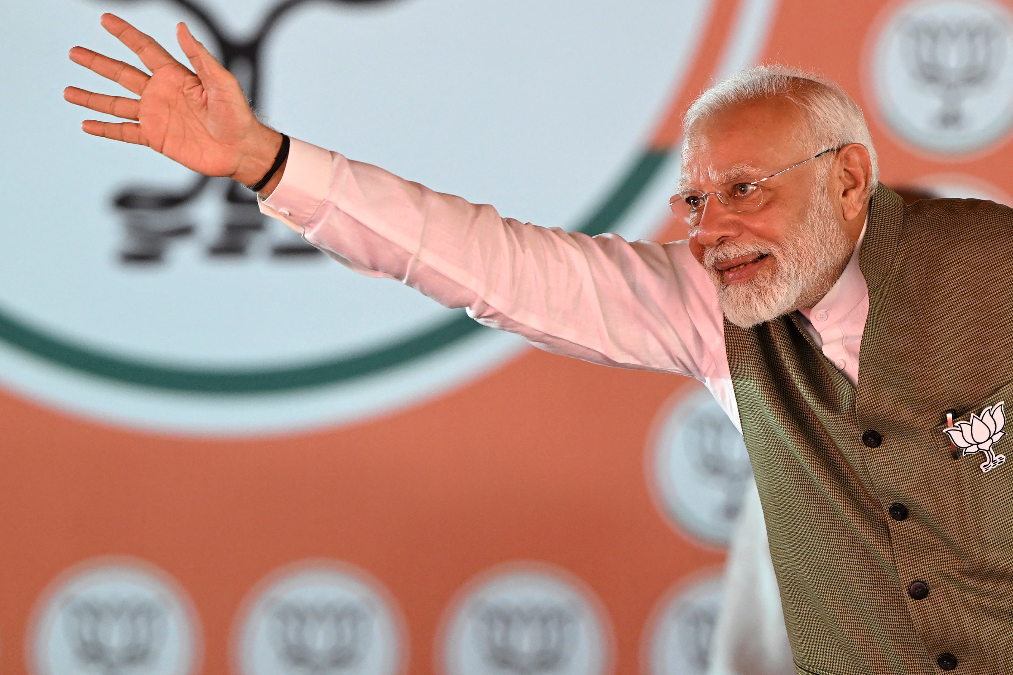 India’s prime minister Narendra Modi waves to his supporters during a rally amid the ongoing local assembly elections, in Srinagar on 19 September 2024