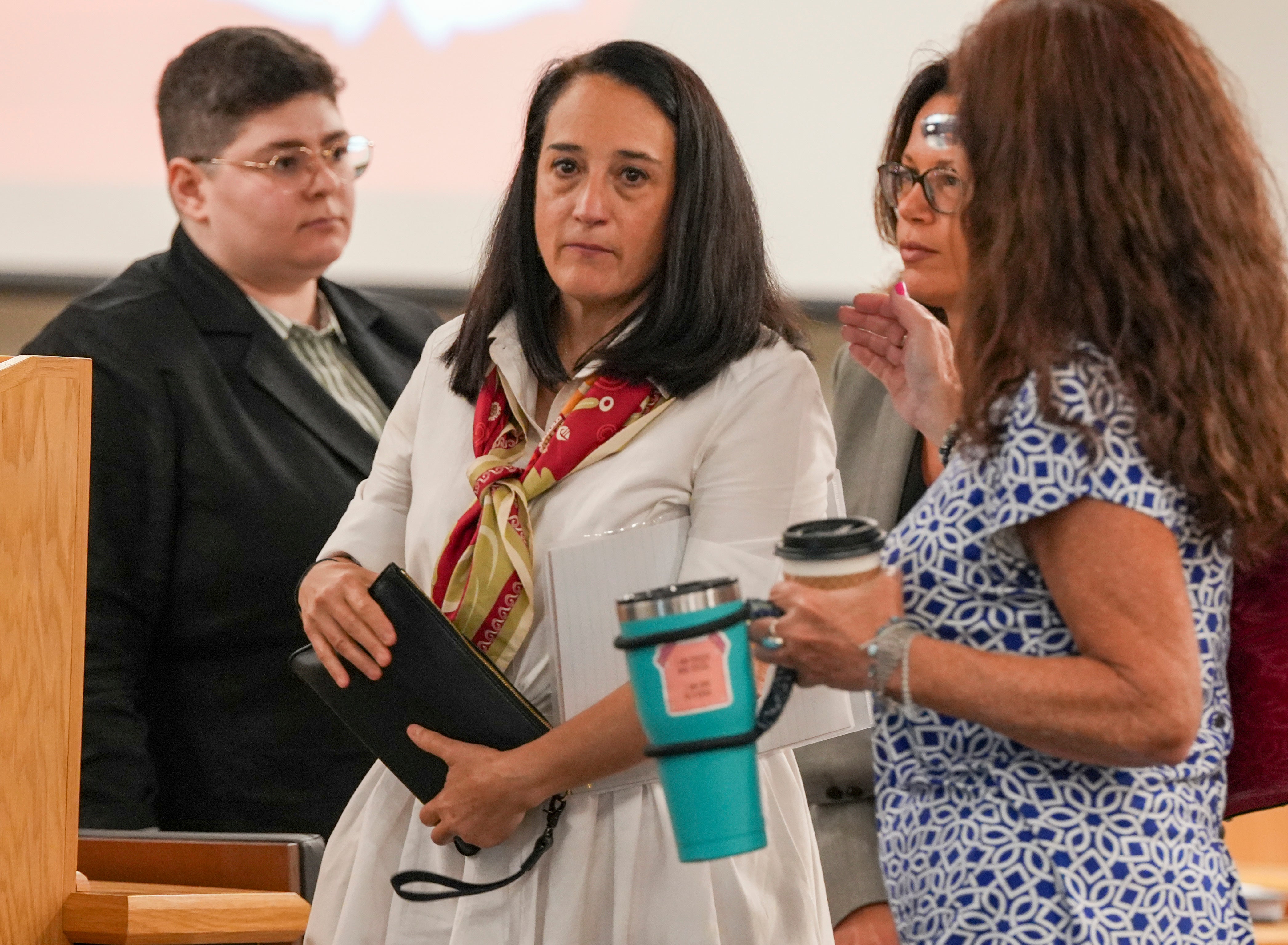 Renata Rojas, OceanGate mission specialist, center, pauses during at the Titan marine board formal hearing, inside the Charleston County Council Chambers on Thursday