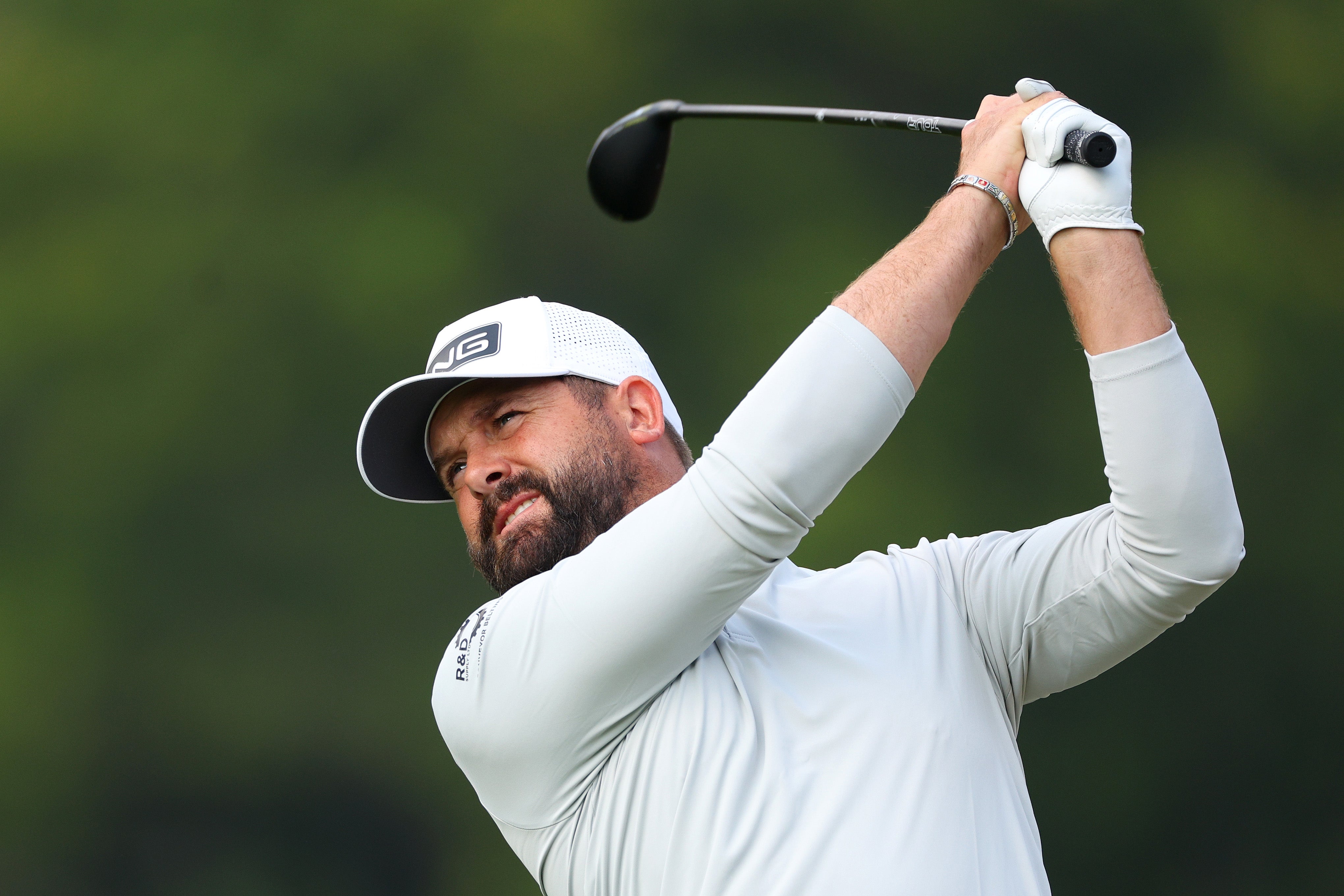 Baldwin fires towards the green on the 18th hole – narrowly escaping the water