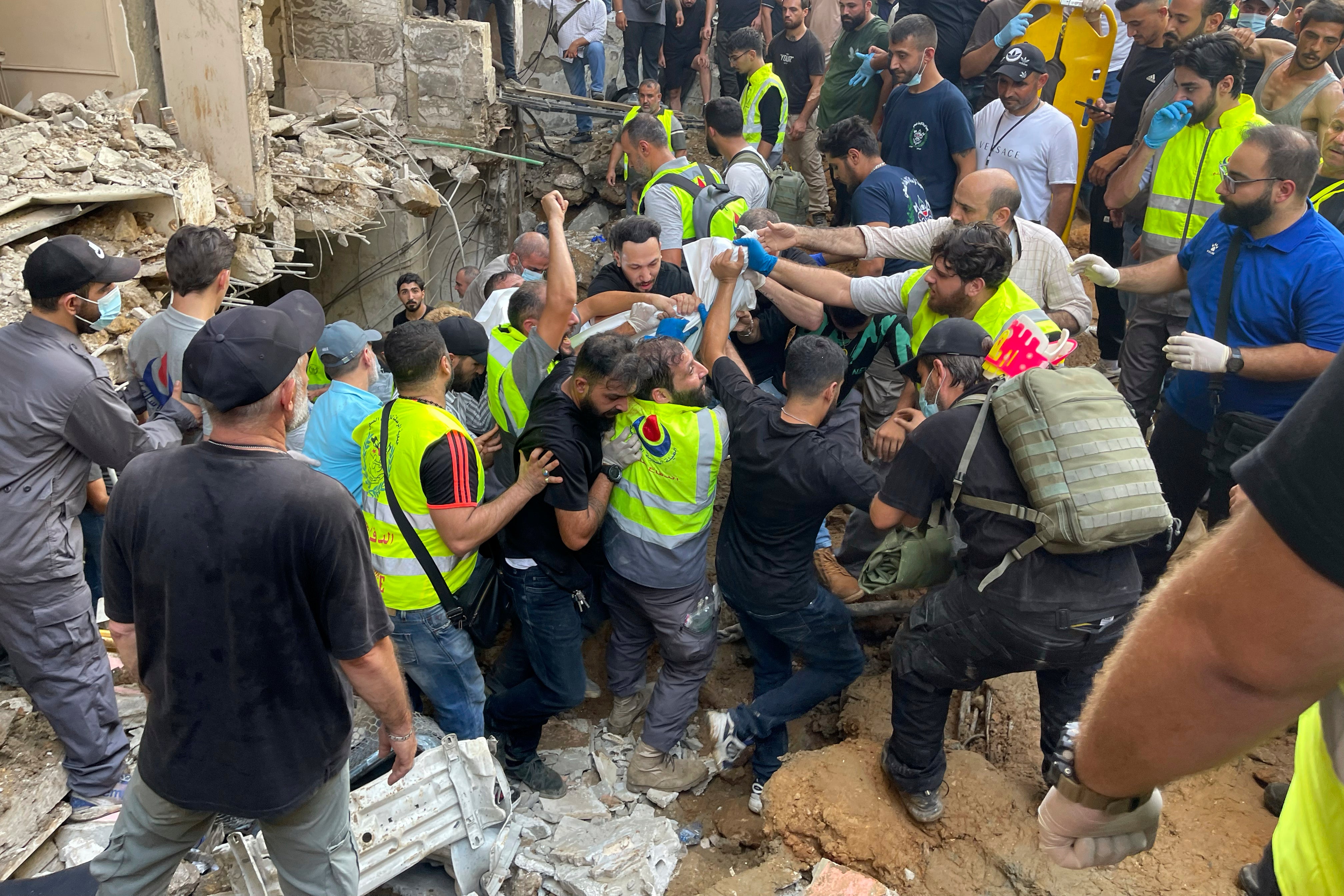 Rescuers carrying a body after a missile strike hit Beirut