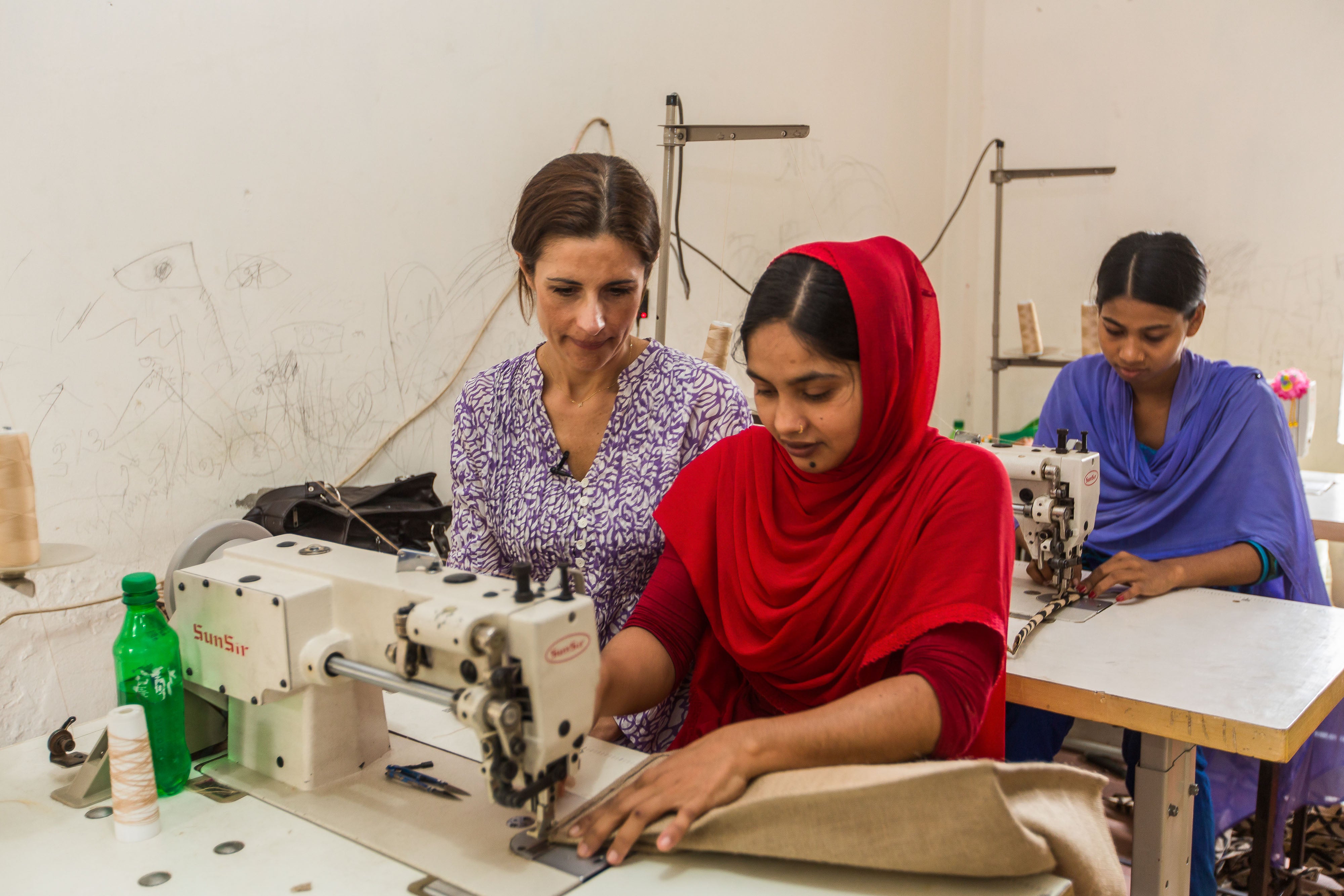 Livia Firth is in conversation with Mili, 24, at Oporajeo, a small enterprise run by the victims of the Rana Plaza disaster in Dhaka, Bangladesh