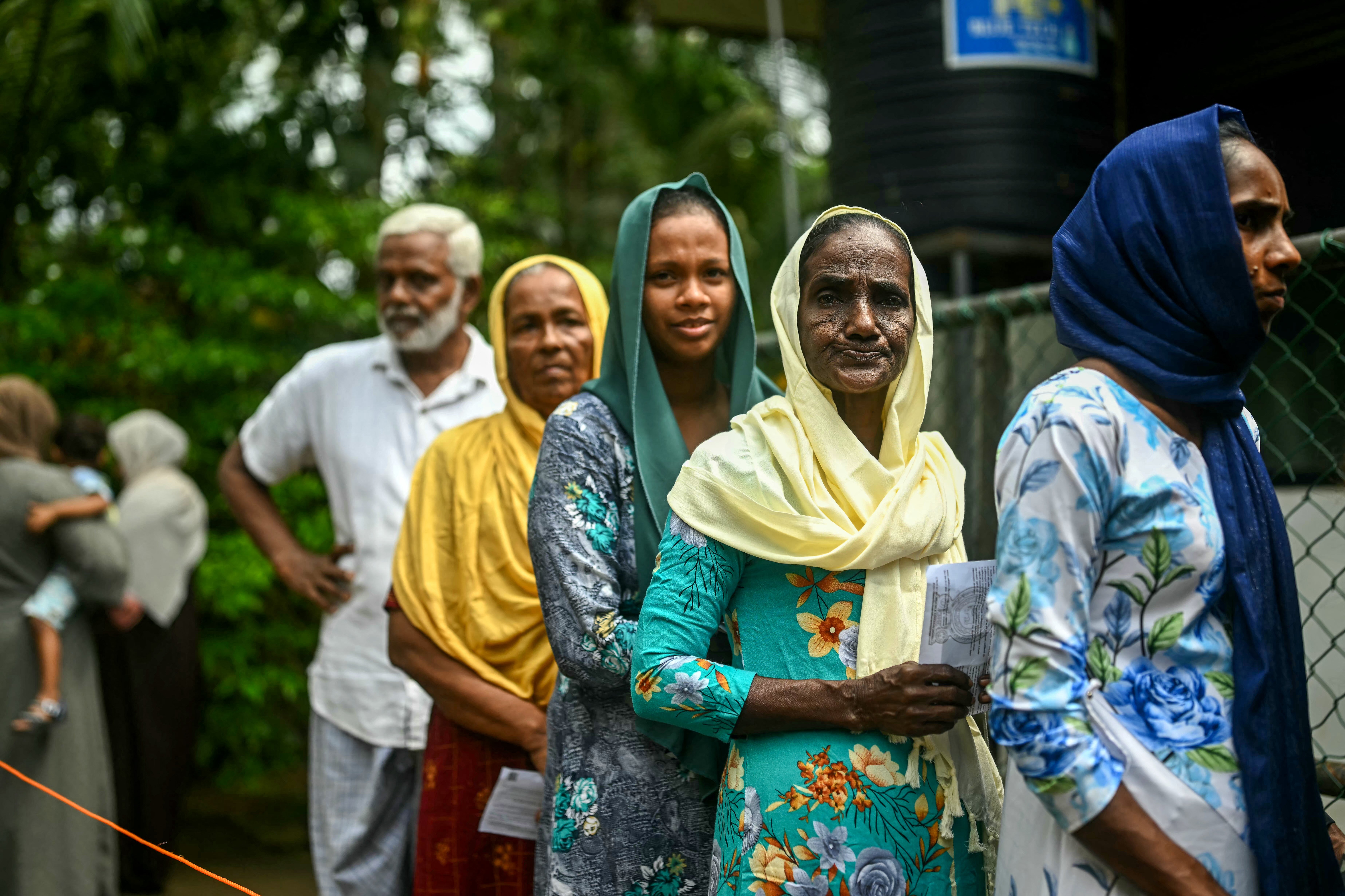 Sri Lankans wait in a queue to cast their ballots in Galle on 21 September