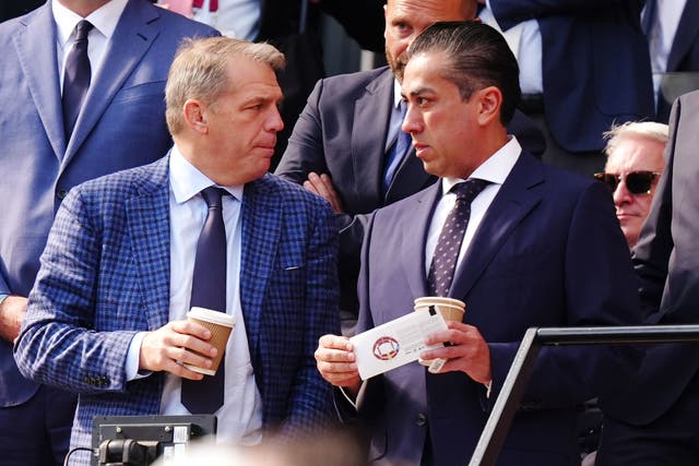 Chelsea co-owners Behdad Eghbali and Todd Boehly (left) speak in the stands at West Ham (PA)