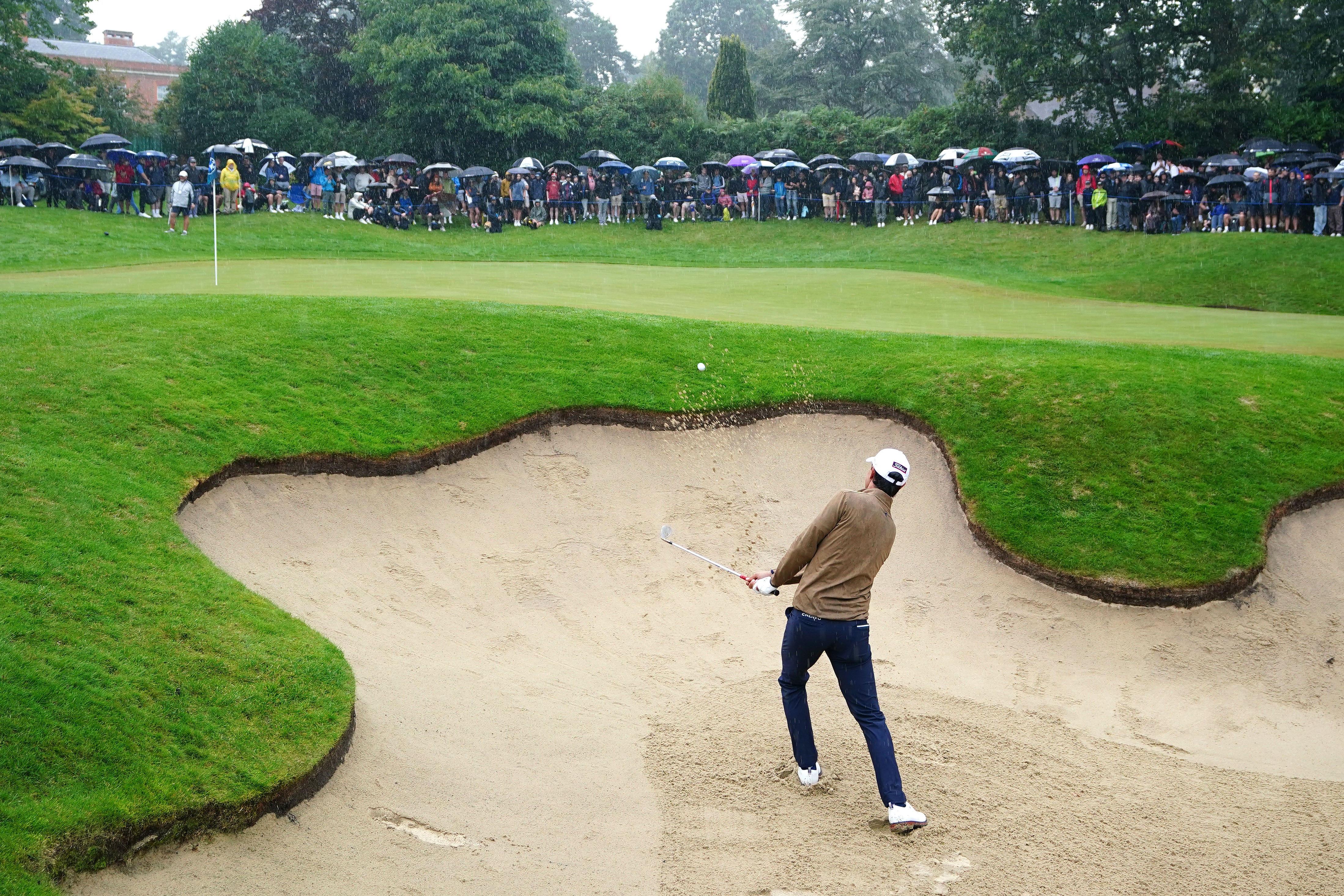 Italy’s Matteo Manassero plays out of a bunker on the third hole during day three of the BMW PGA Championship (Zac Goodwin/PA)