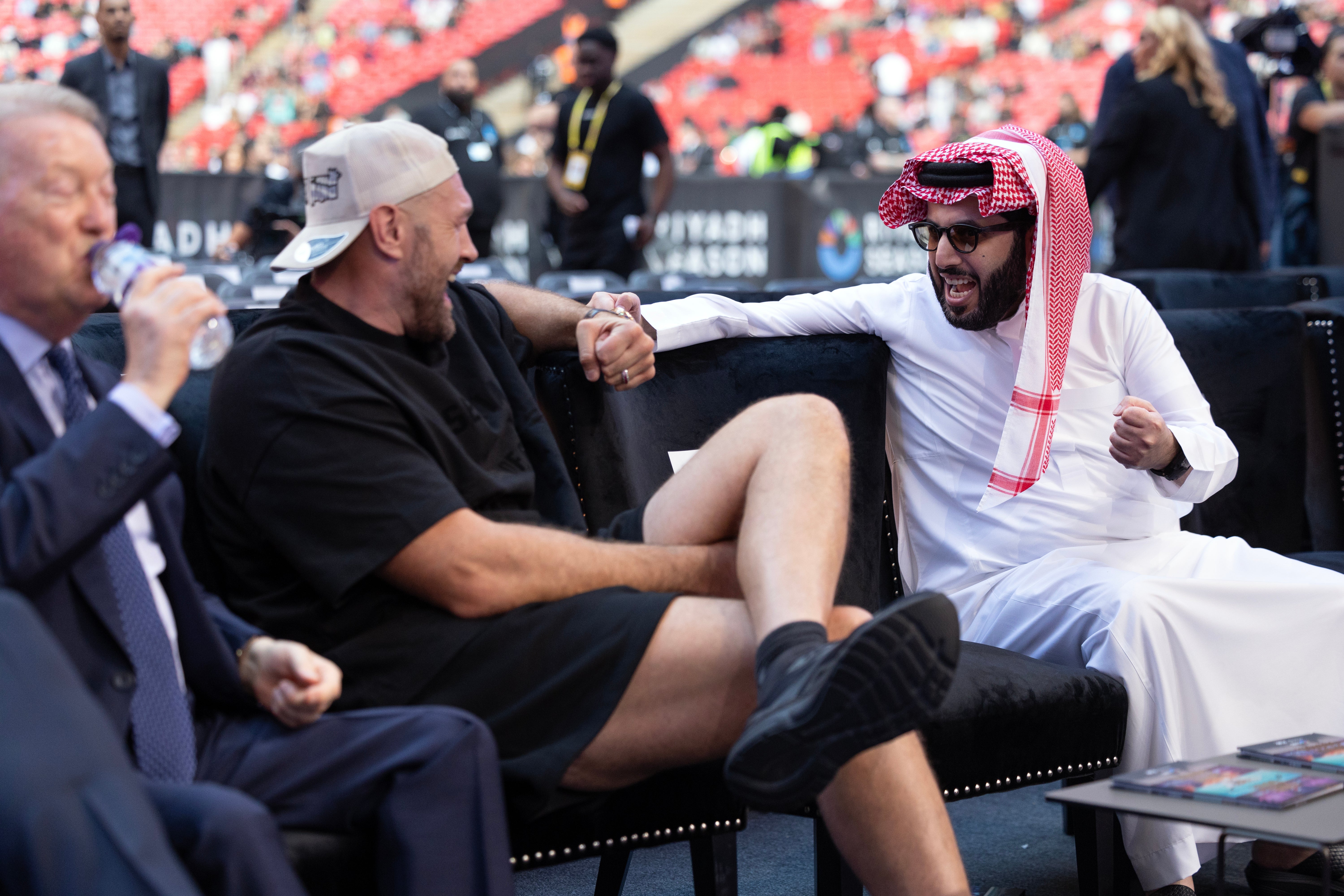 Tyson Fury and Turki Alalshikh chat at ringside