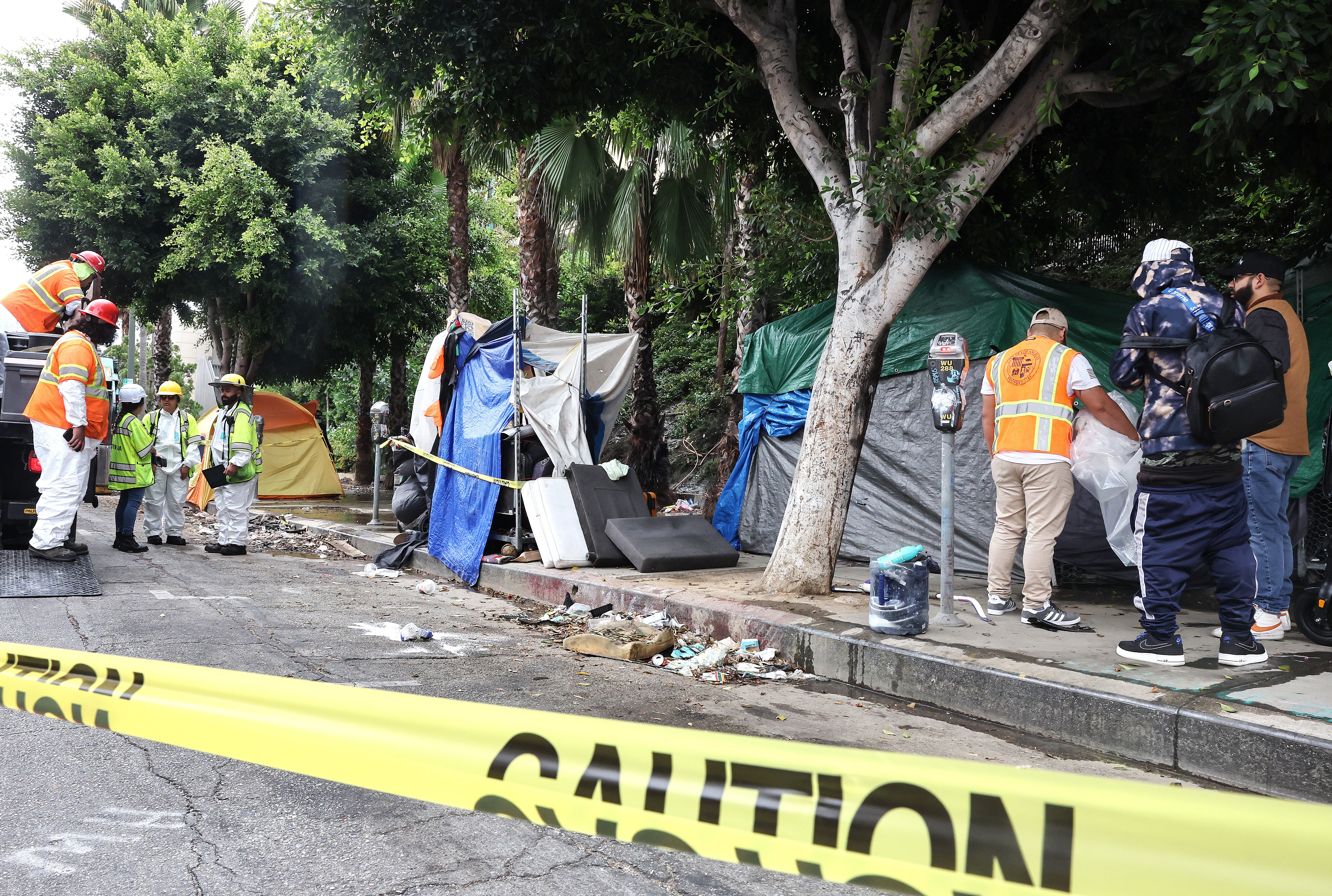 Members of the Los Angeles’ Inside Safe team help an unhoused person make their way from an encampment to a bus to be brought to interim housing, as part of an ‘Inside Safe’ operation in September. The US is on pace for its highest homeless population count ever.