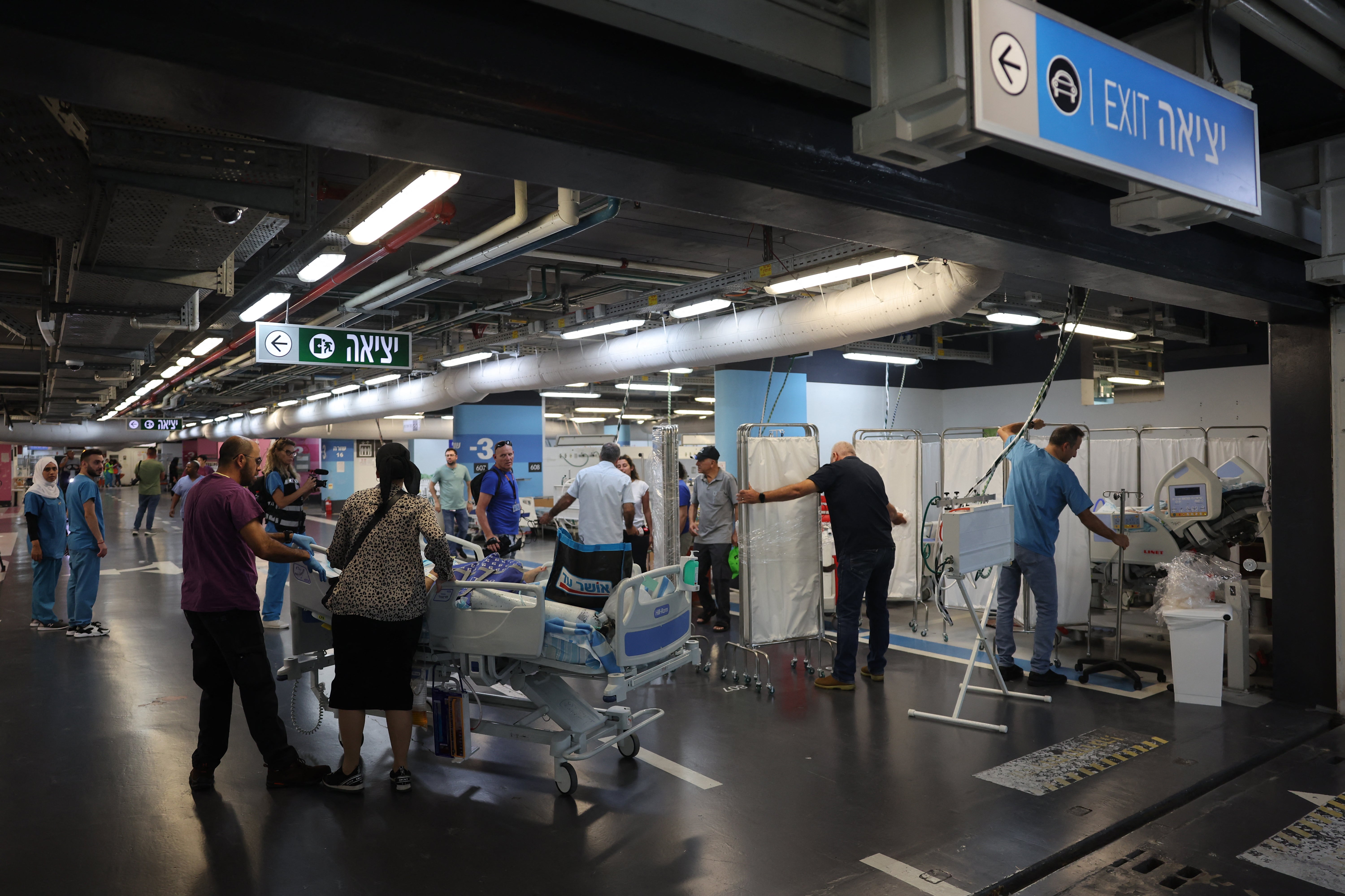 Patients and staff at Haifa’s Rambam Hospital evacuate to lower floors on Sunday after rockets were fired into the area from Lebanon