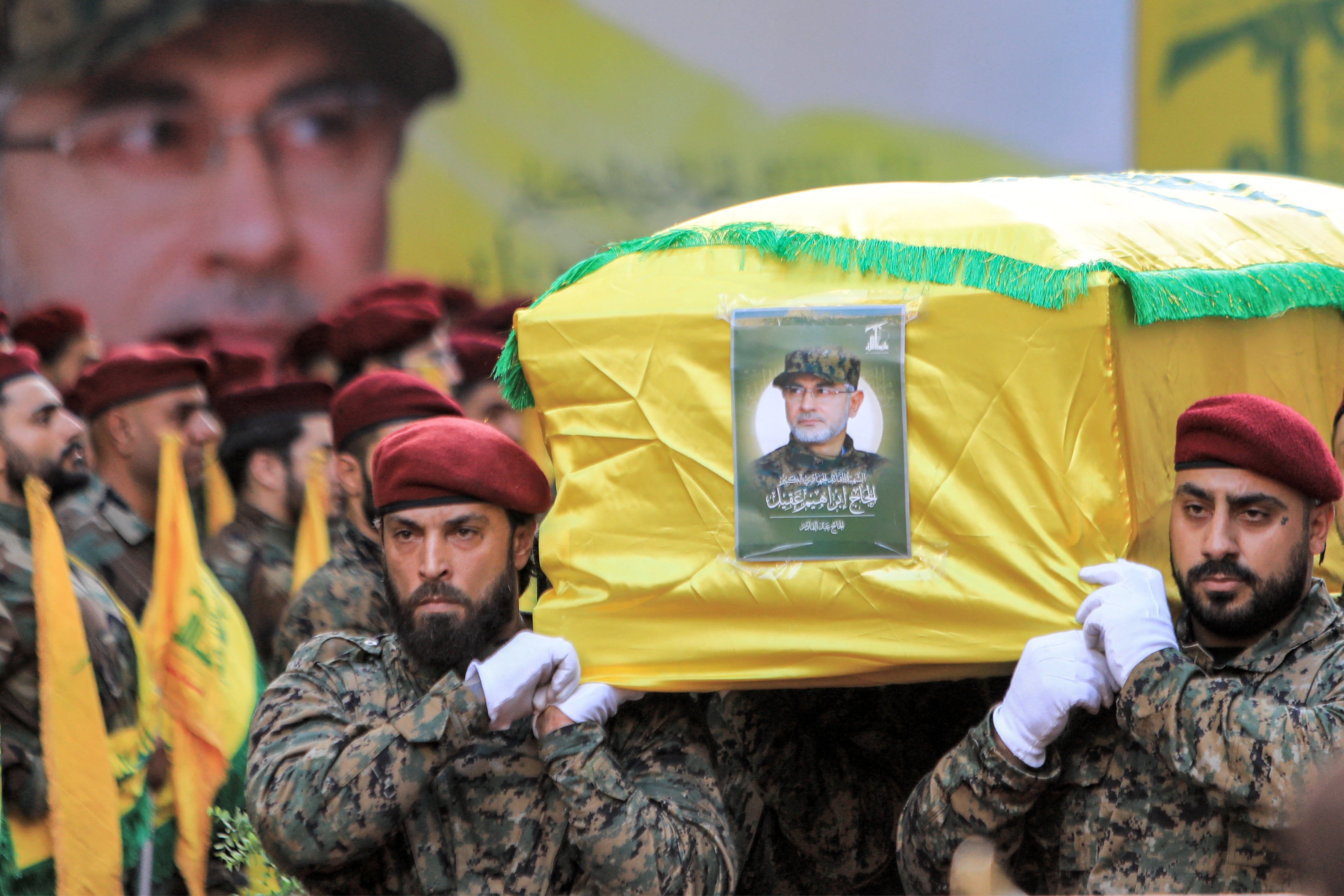 Hezbollah fighters carry the body of commander Ibrahim Aqil at his funeral in southern Beirut on Sunday