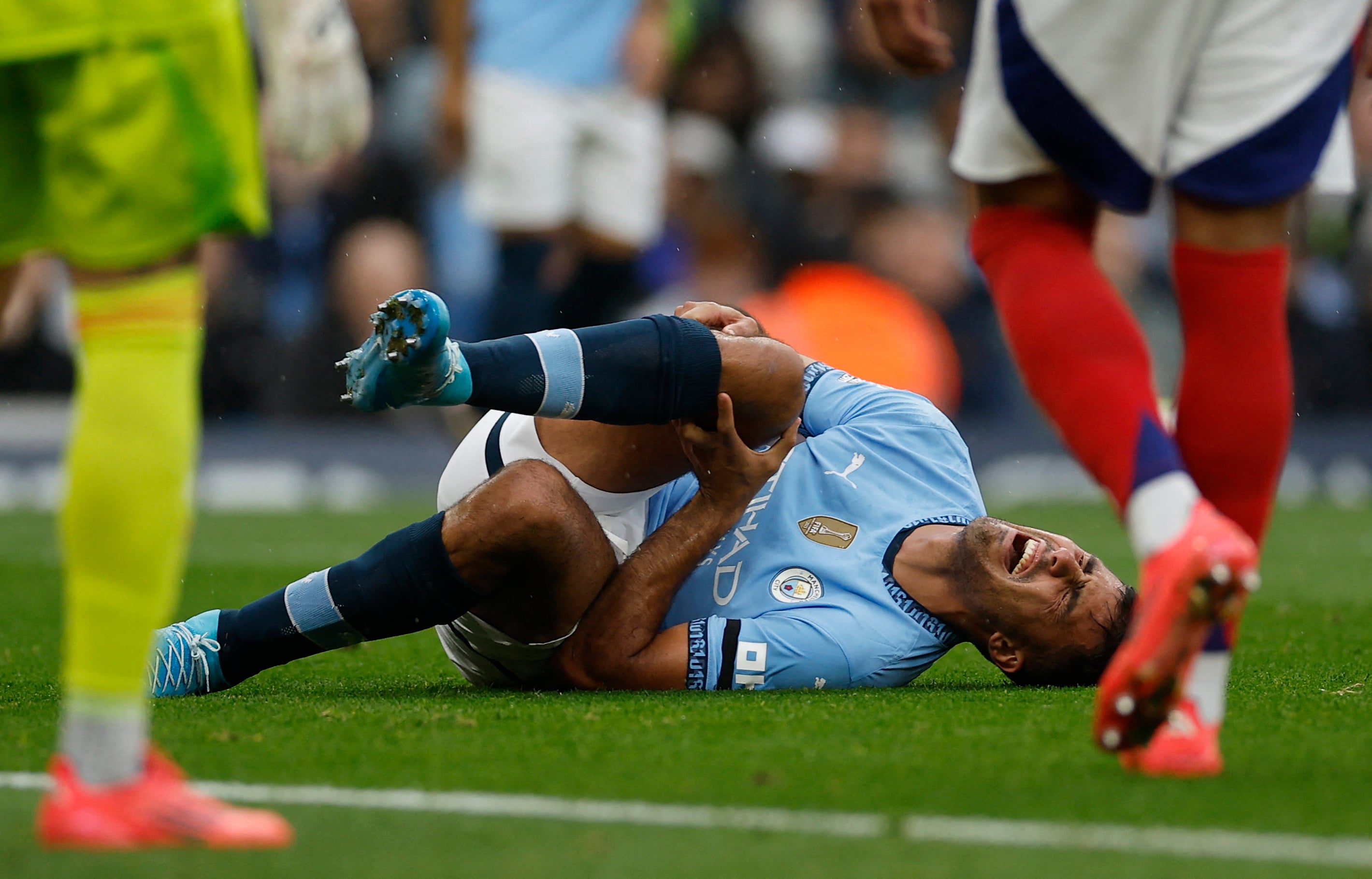 Rodri writhes in pain on the ground during Manchester City’s match with Arsenal