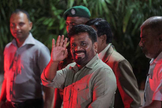 <p>Anura Kumara Dissanayake, leader of the National People's Power (NPP) party, greets people as he leaves the election commission after claiming victory in the presidential election in Colombo, Sri Lanka, 22 September 2024</p>