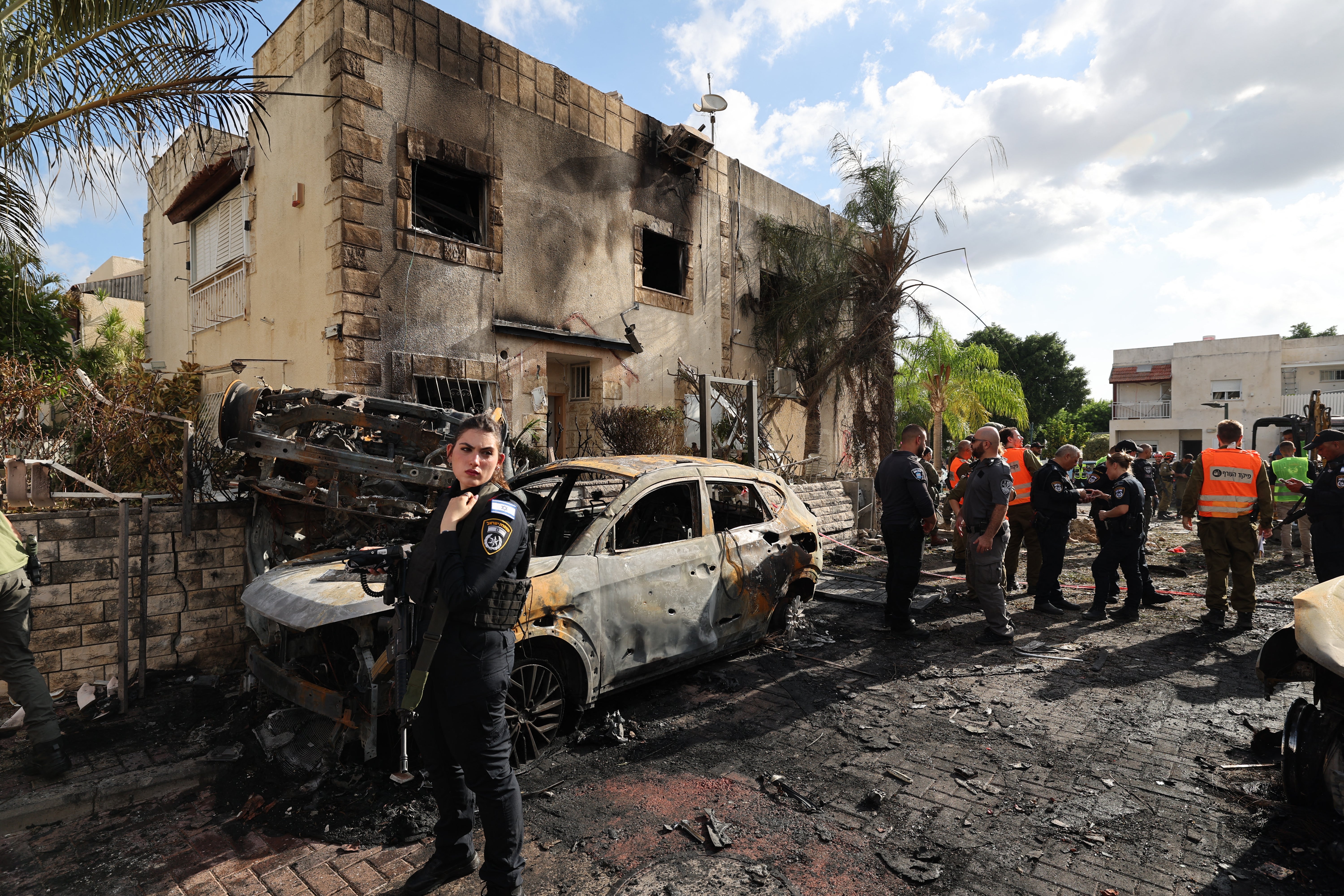 First responders and Israeli security forces gather amid debris and charred vehicles in Kiryat Bialik in the Haifa district of Israel, following a reported strike by Lebanon’s Hezbollah on 22 September 2024