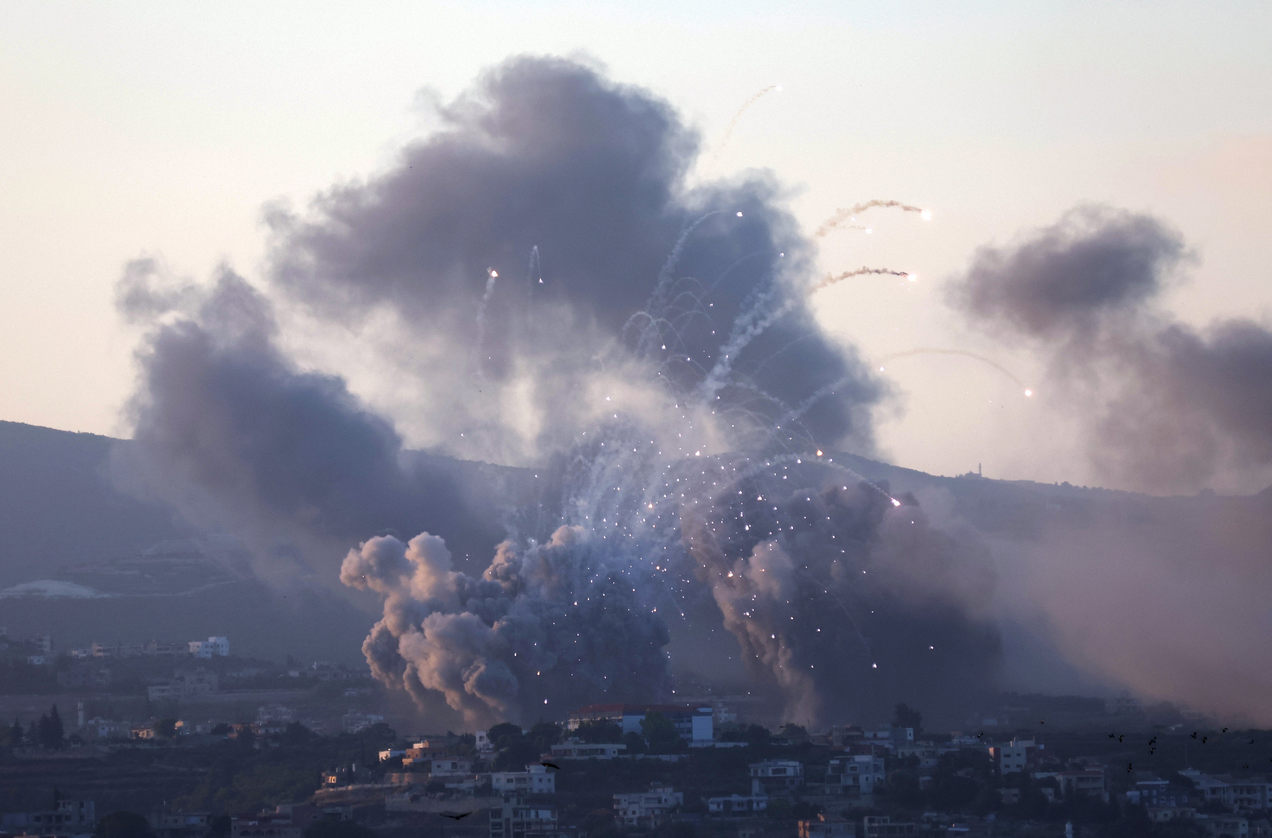 Smoke billows over southern Lebanon following Israeli strikes, amid ongoing cross-border hostilities between Hezbollah and Israeli forces, as seen from Tyre, southern Lebanon 23 September 2024