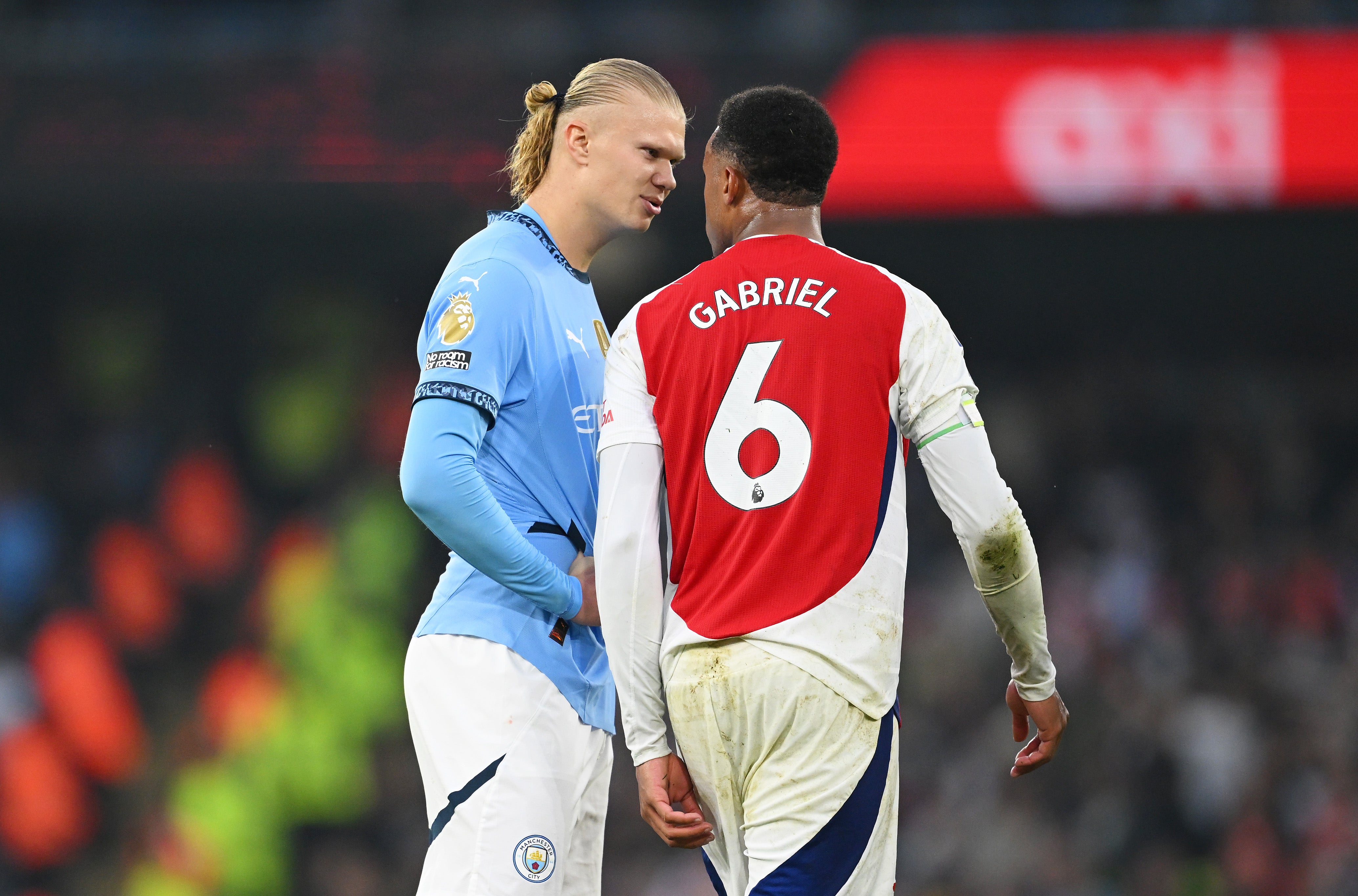 Gabriel clashes with Erling Haaland at the Etihad Stadium