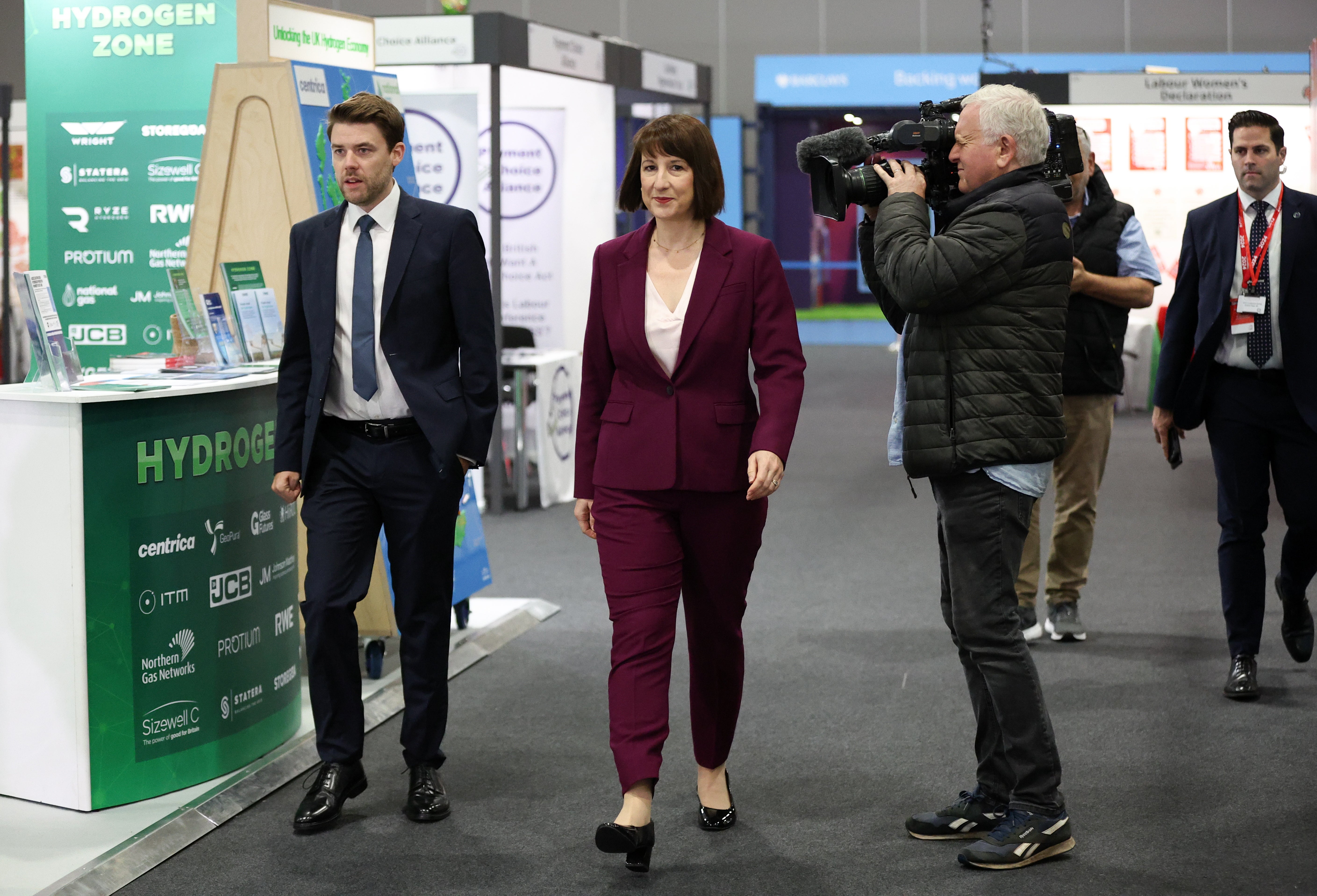 Rachel Reeves (C) walks through the conference centre at the Labour Party Conference in Liverpool