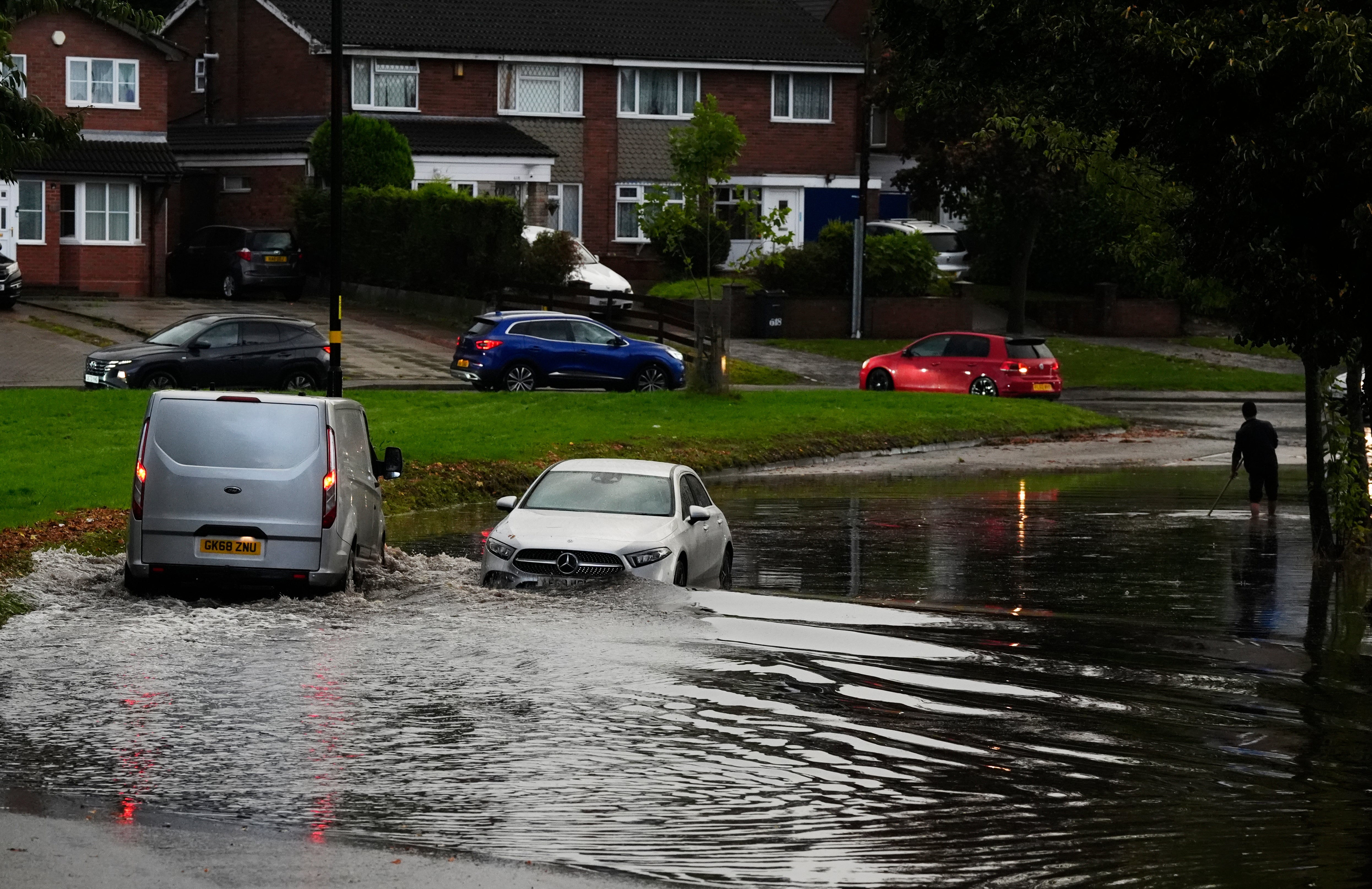 Vehicles drive through floodwater in Birmingham as the Environment Agency warned of widespread flooding