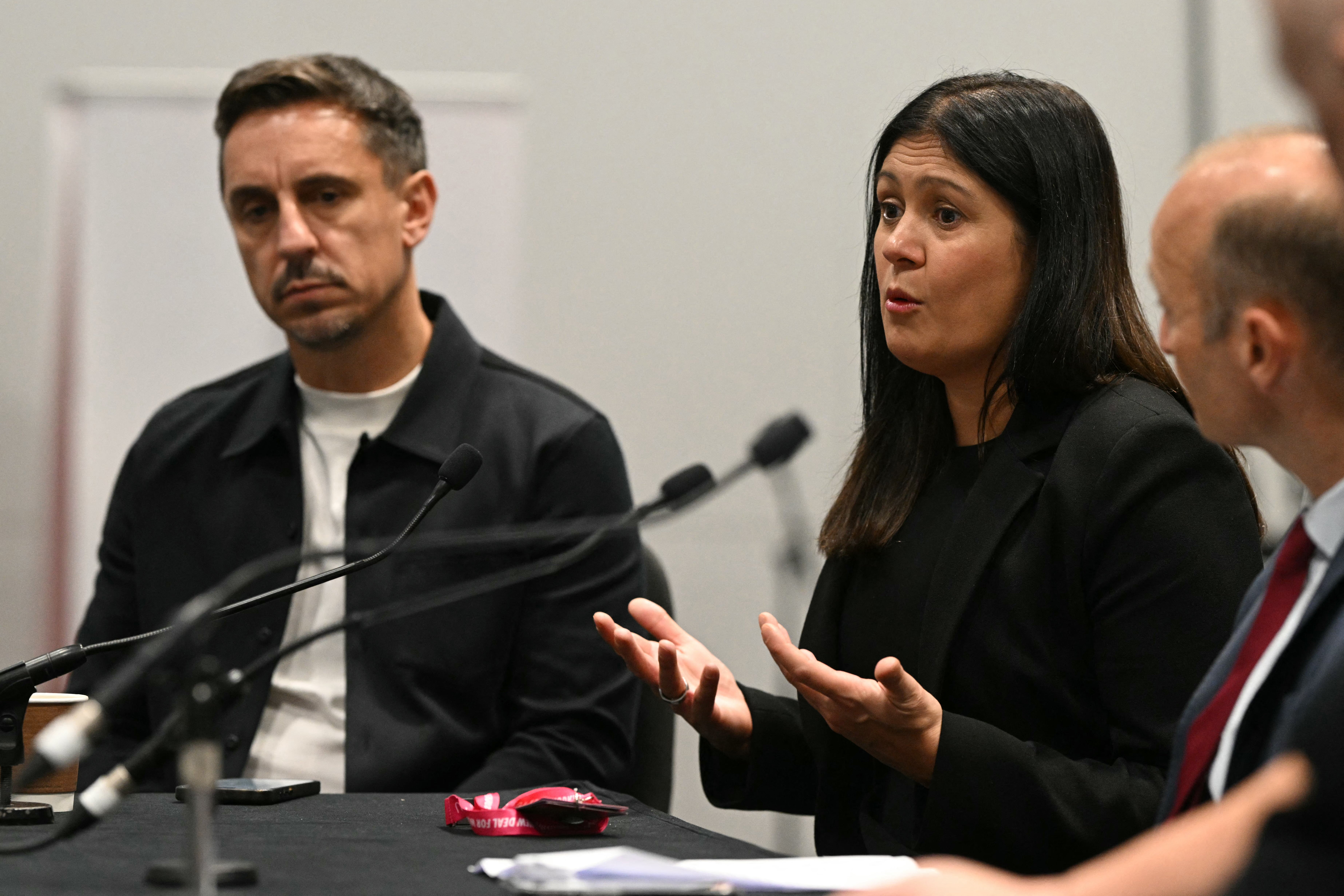 Britain's Culture, Media and Sport Secretary Lisa Nandy speaks during an English Football League panel fringe event with former footballer Gary Neville (L) on the second day of the annual Labour Party conference in Liverpool