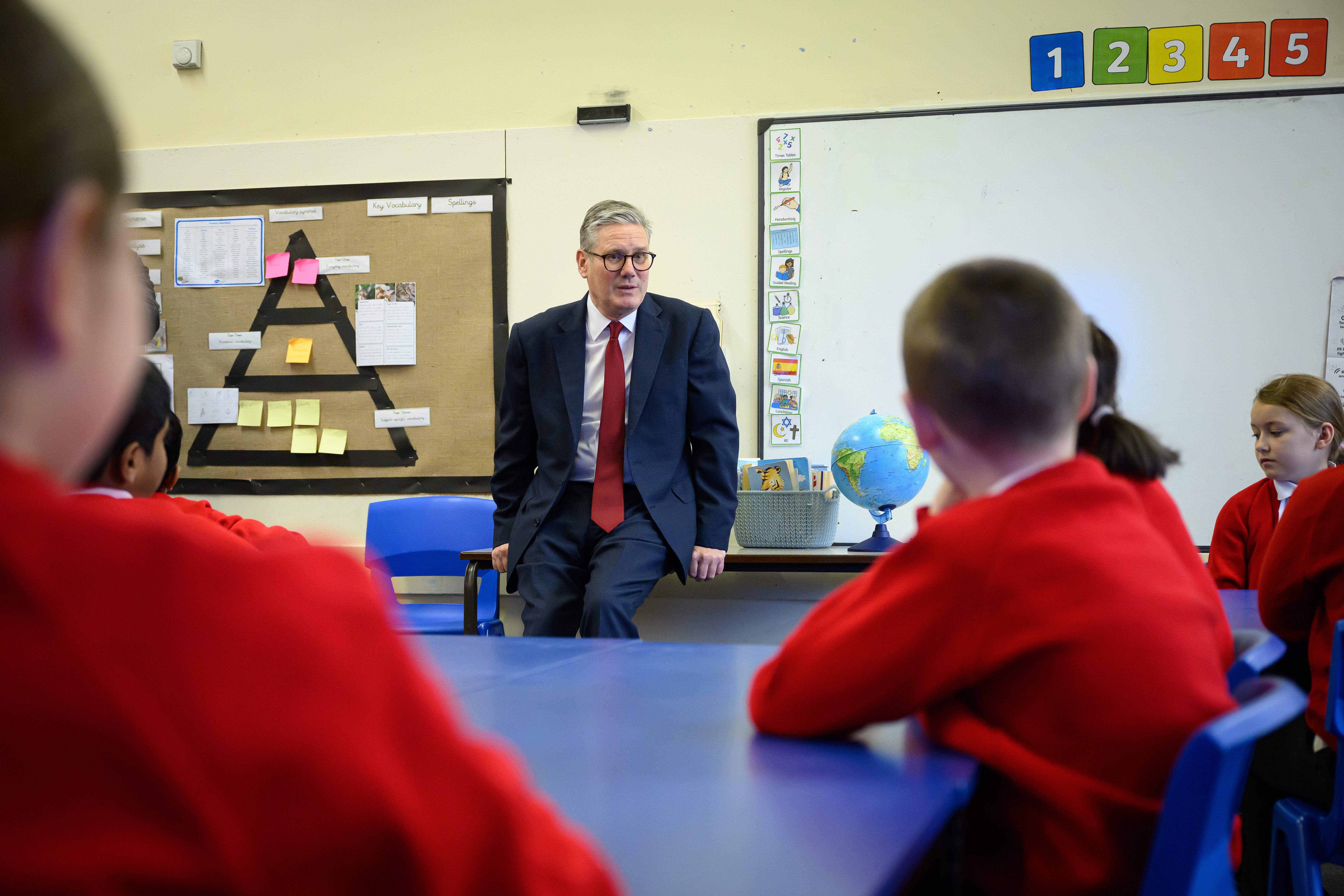 Keir Starmer speaks with pupils at Holy Cross Catholic Primary School during a visit in Liverpool