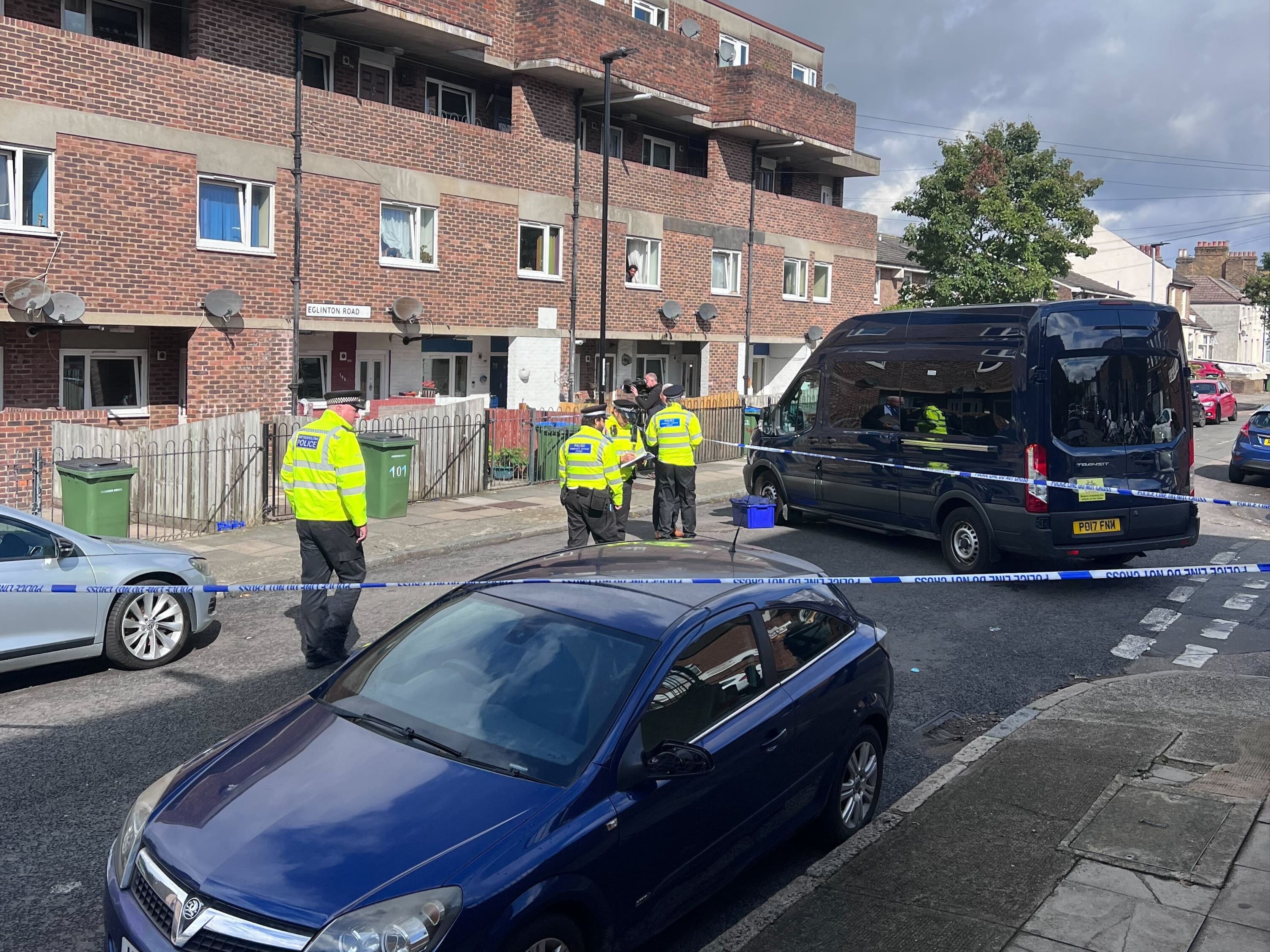 Police officers work at the scene of the fatal stabbing in Woolwich