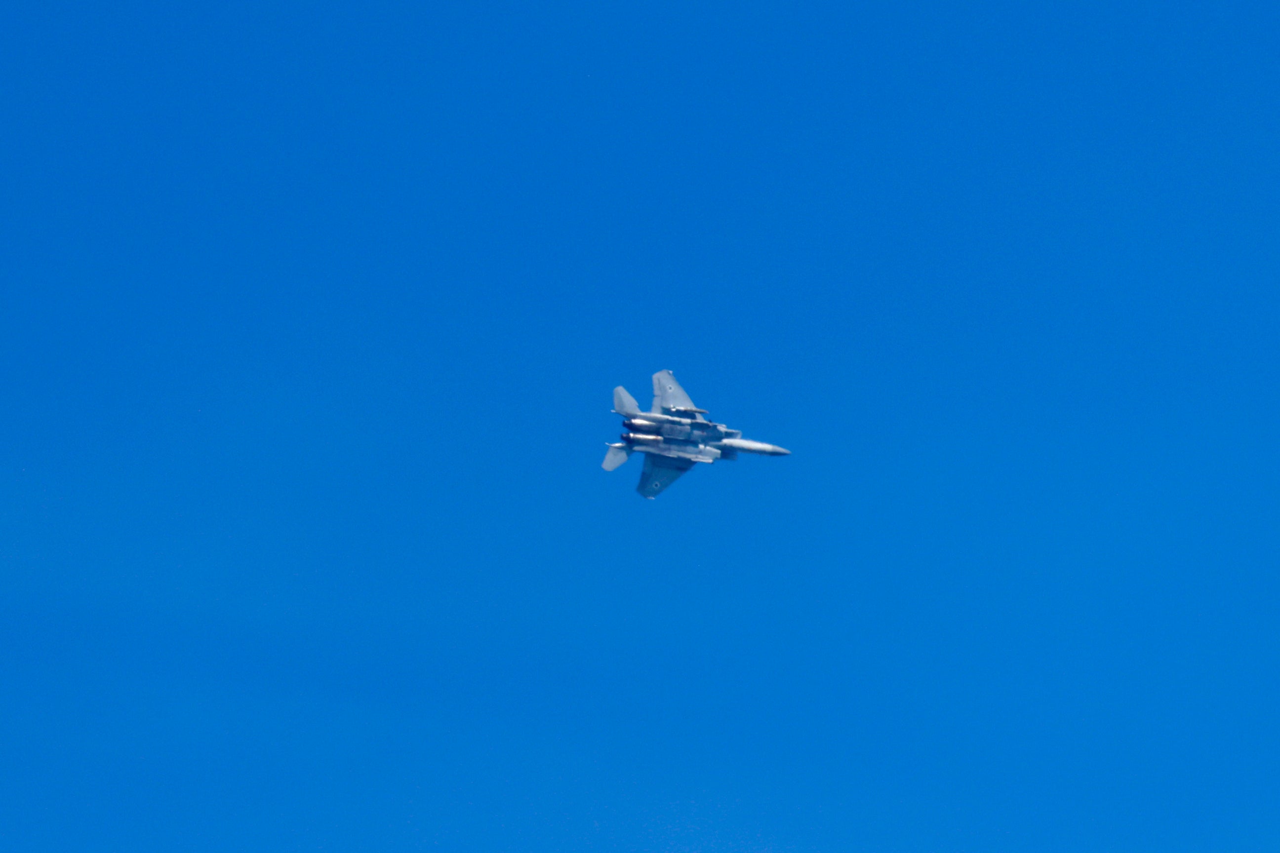 An Israeli fighter jet flies over the Israeli port city of Haifa