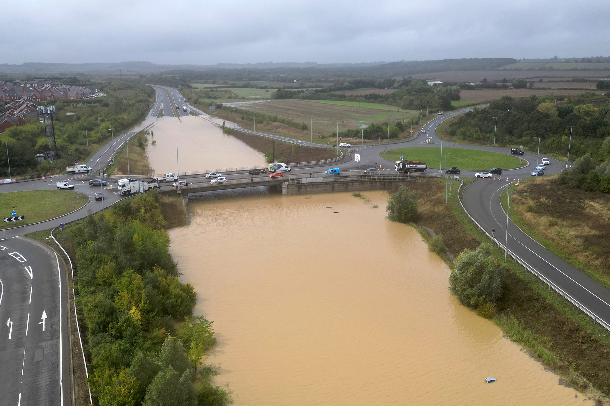 The open boot of a car visible above the water in a flooded area