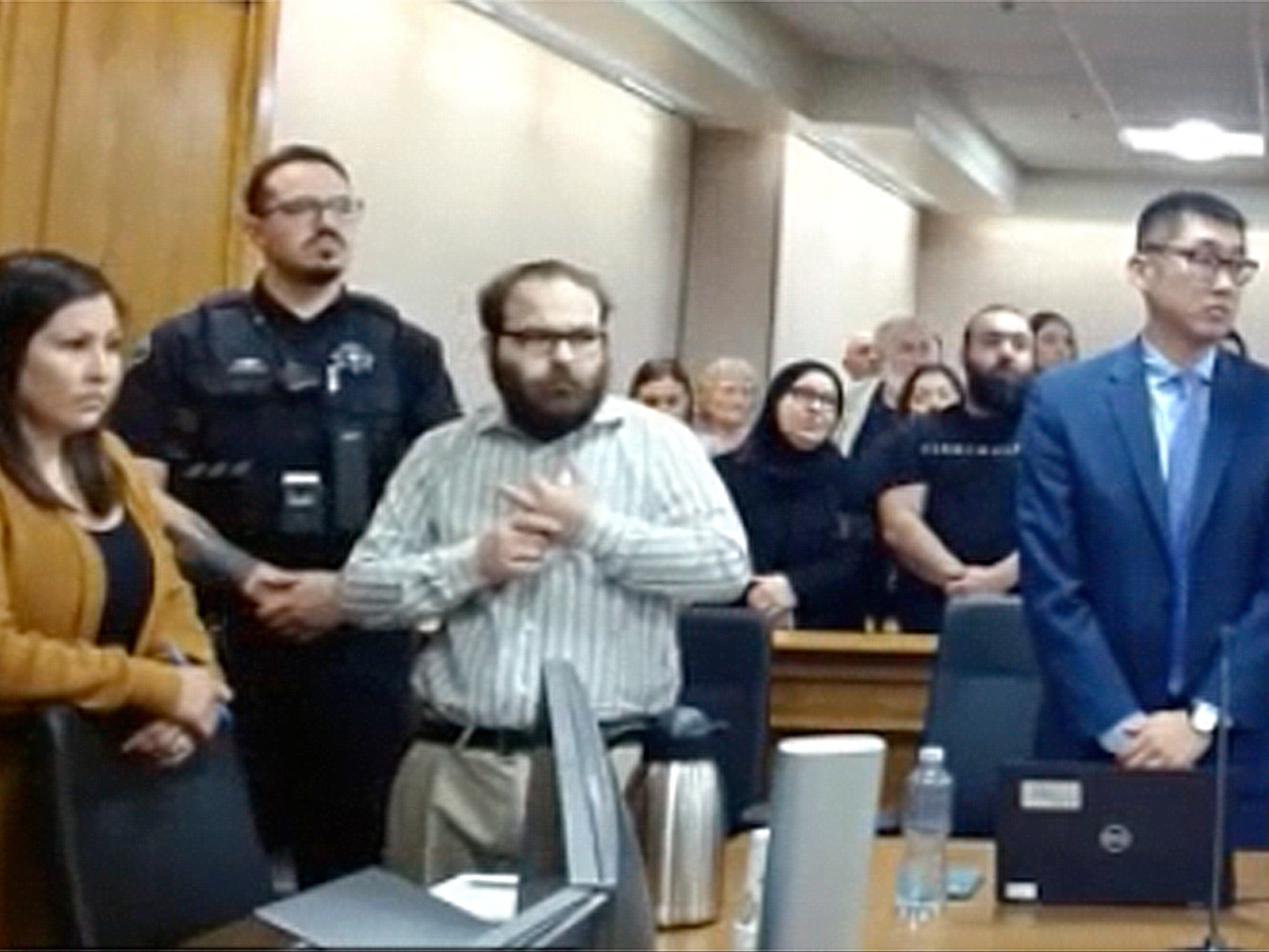 Alissa, third from left, stands for the verdict in his trial for the 2021 Colorado supermarket shootings on Monday