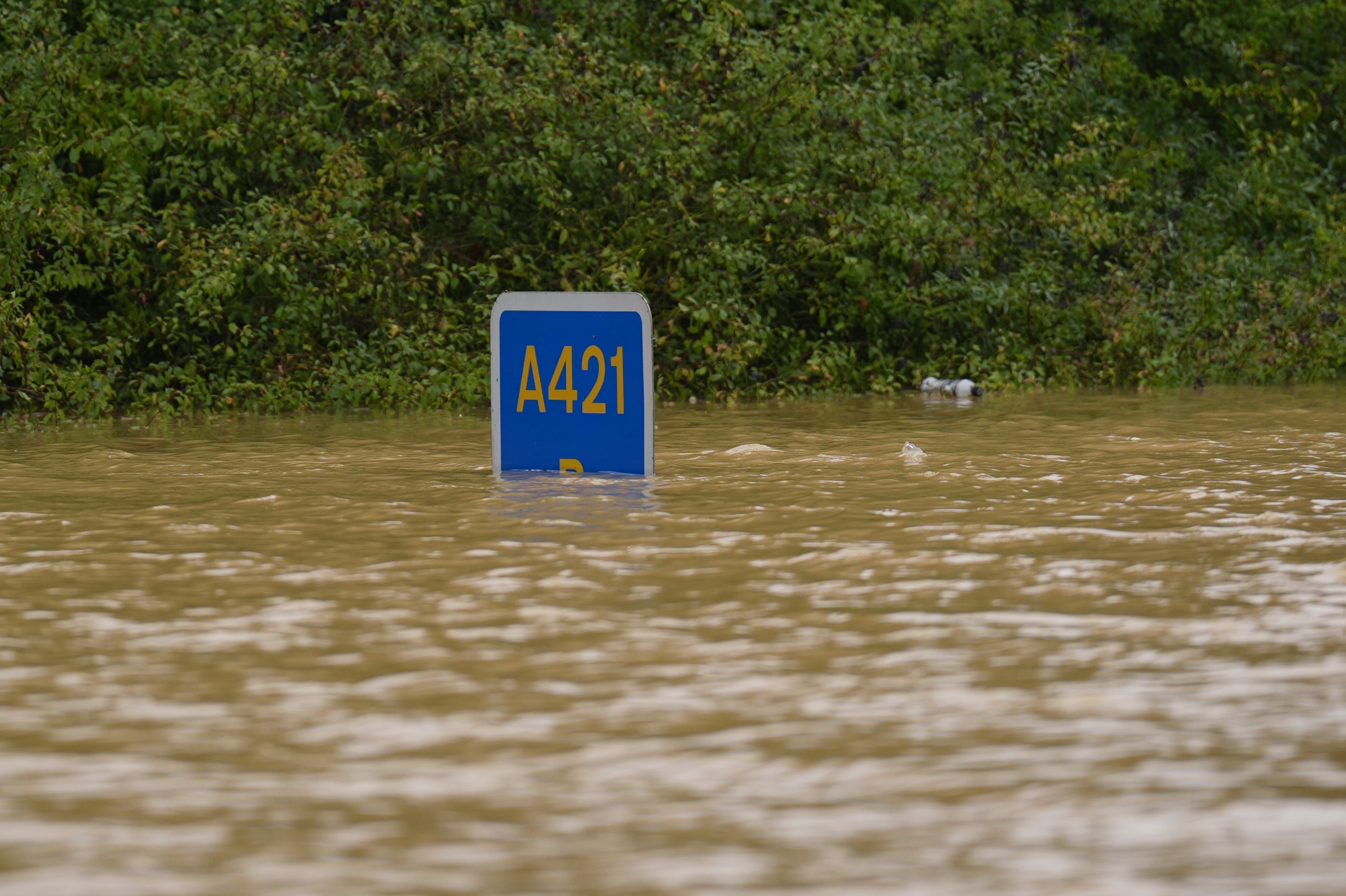 A road sign submerged in flood water on the A421 in Marston Moretaine, Bedfordshire (Joe Giddens/PA)