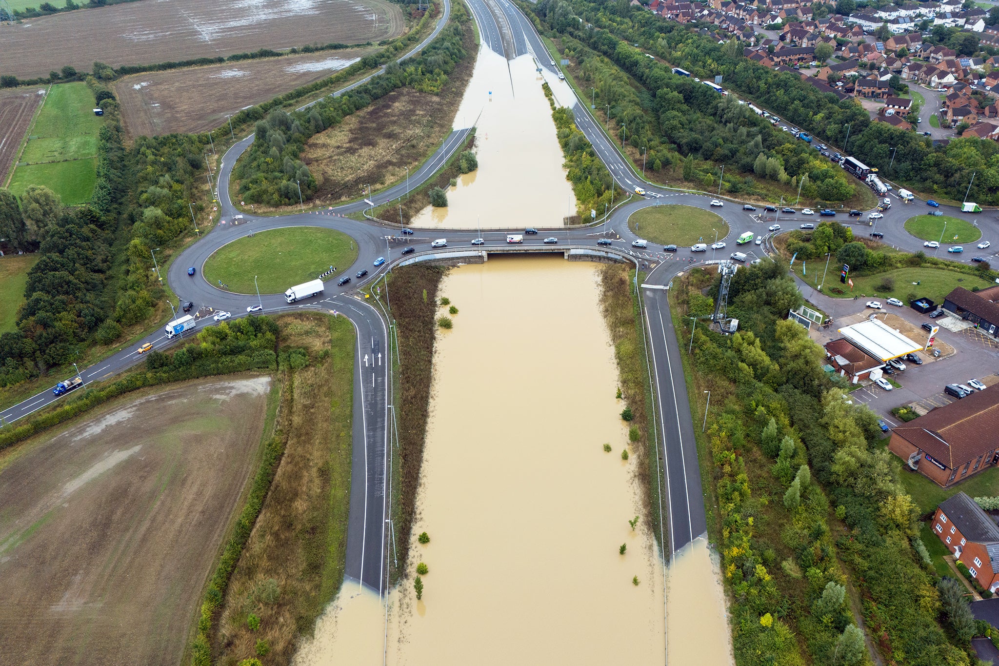 Cars were left floating in the A421 after flash flooding submerged the dual carriageway