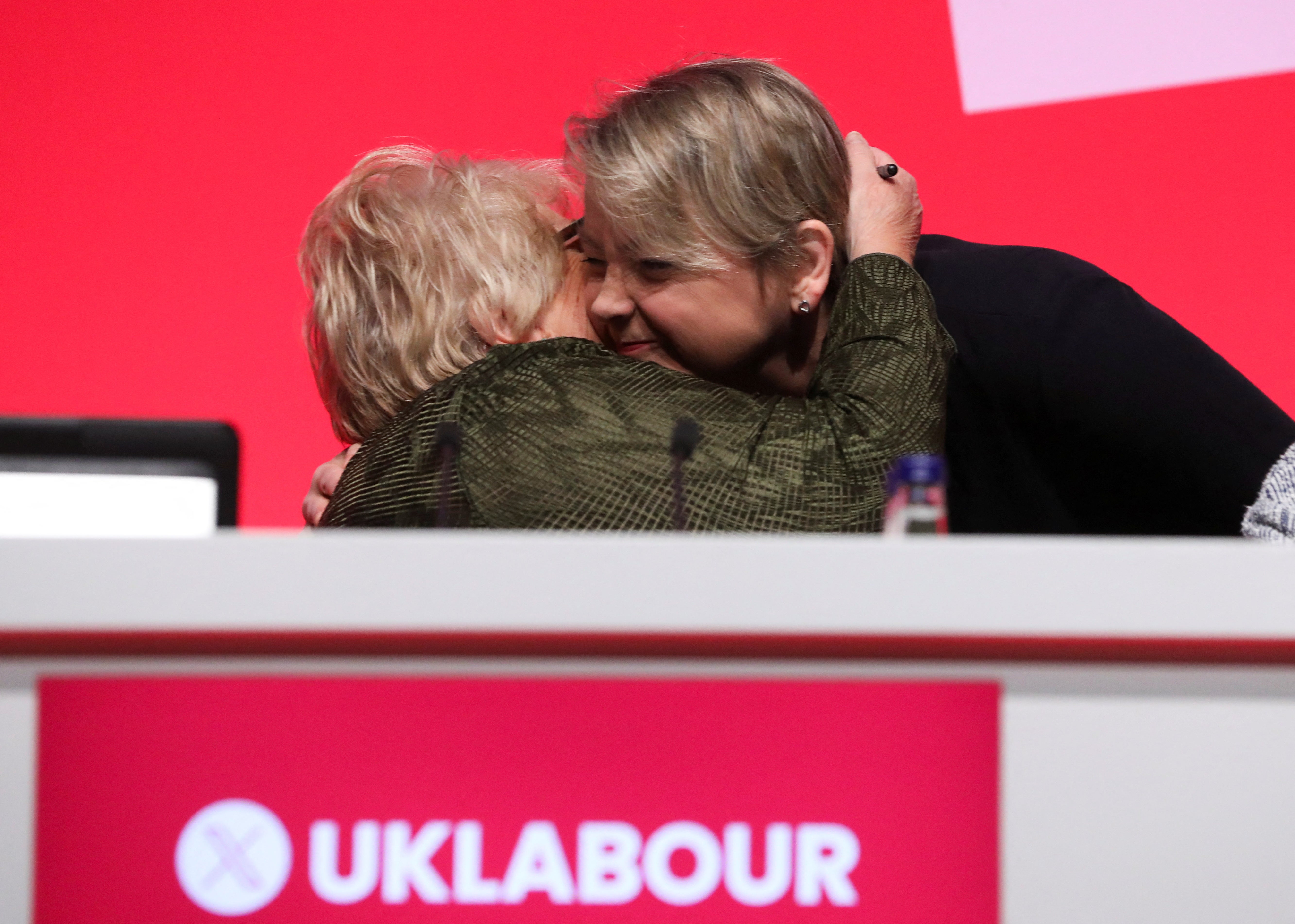 Yvette Cooper is embraced on stage at Britain's Labour Party's annual conference in Liverpool