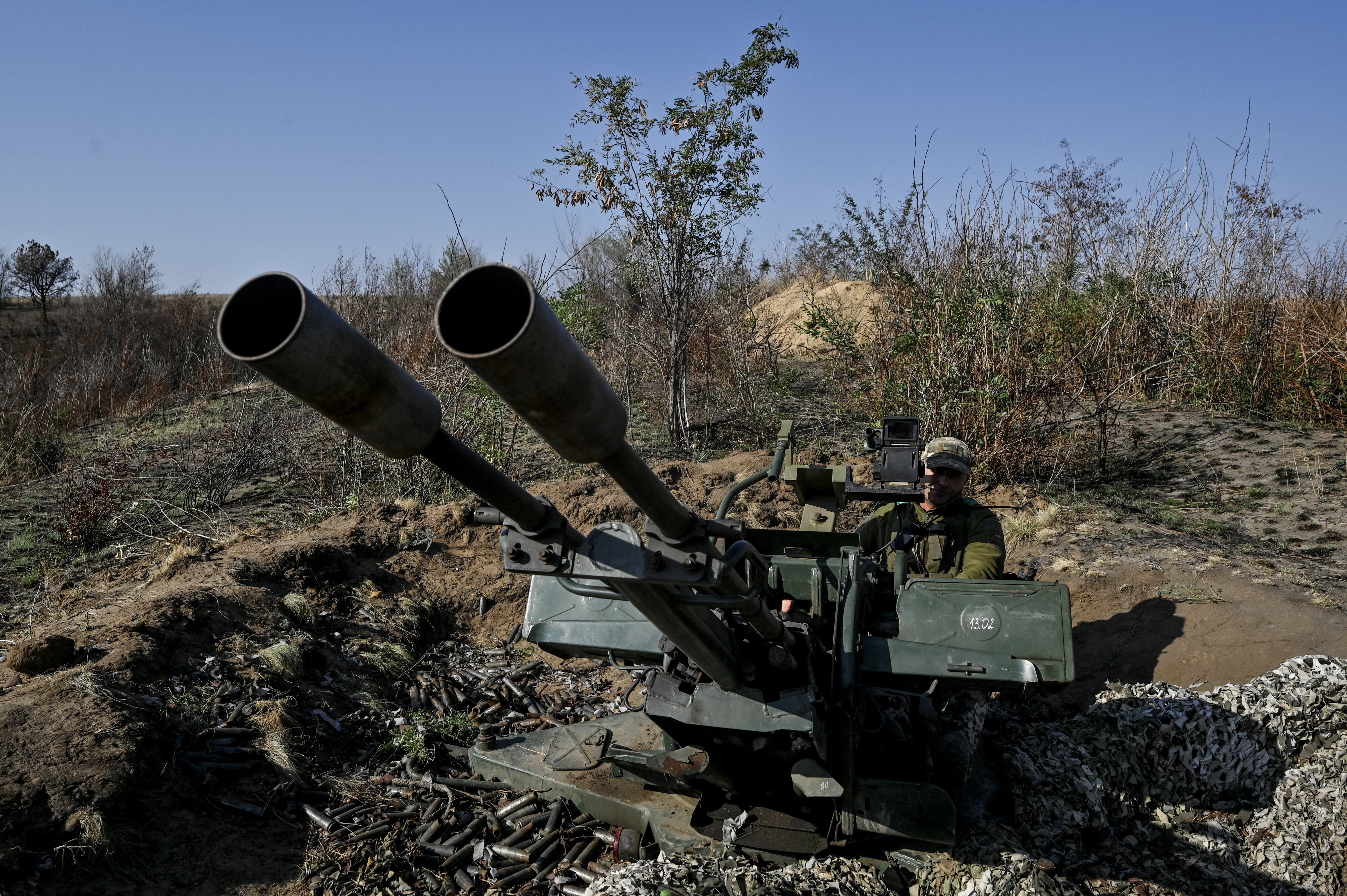 A Ukrainian serviceman operates ZU-23-2 anti-aircraft cannon during a combat shift near a frontline