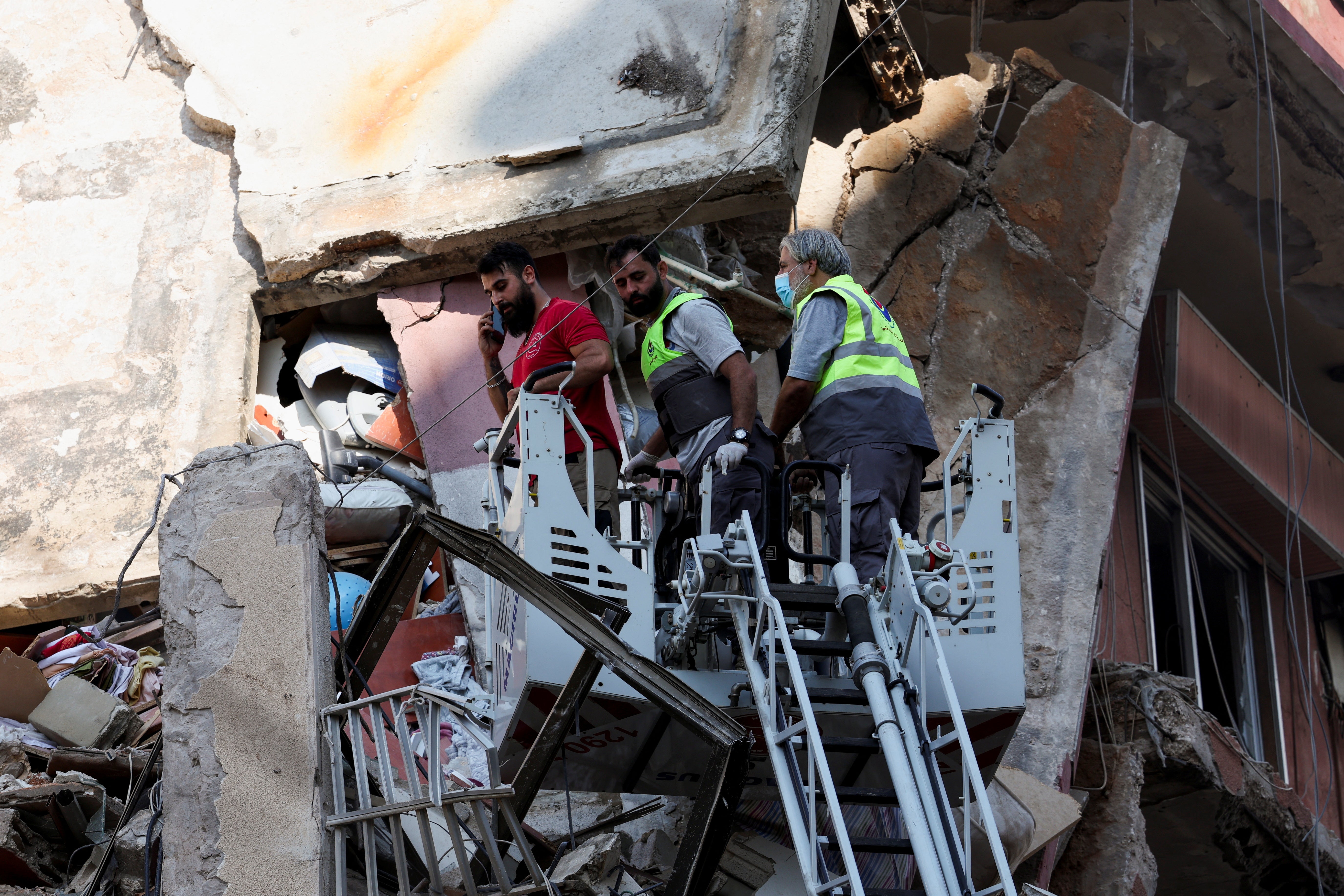 Members of the civil defence and firefighting unit are working at the site