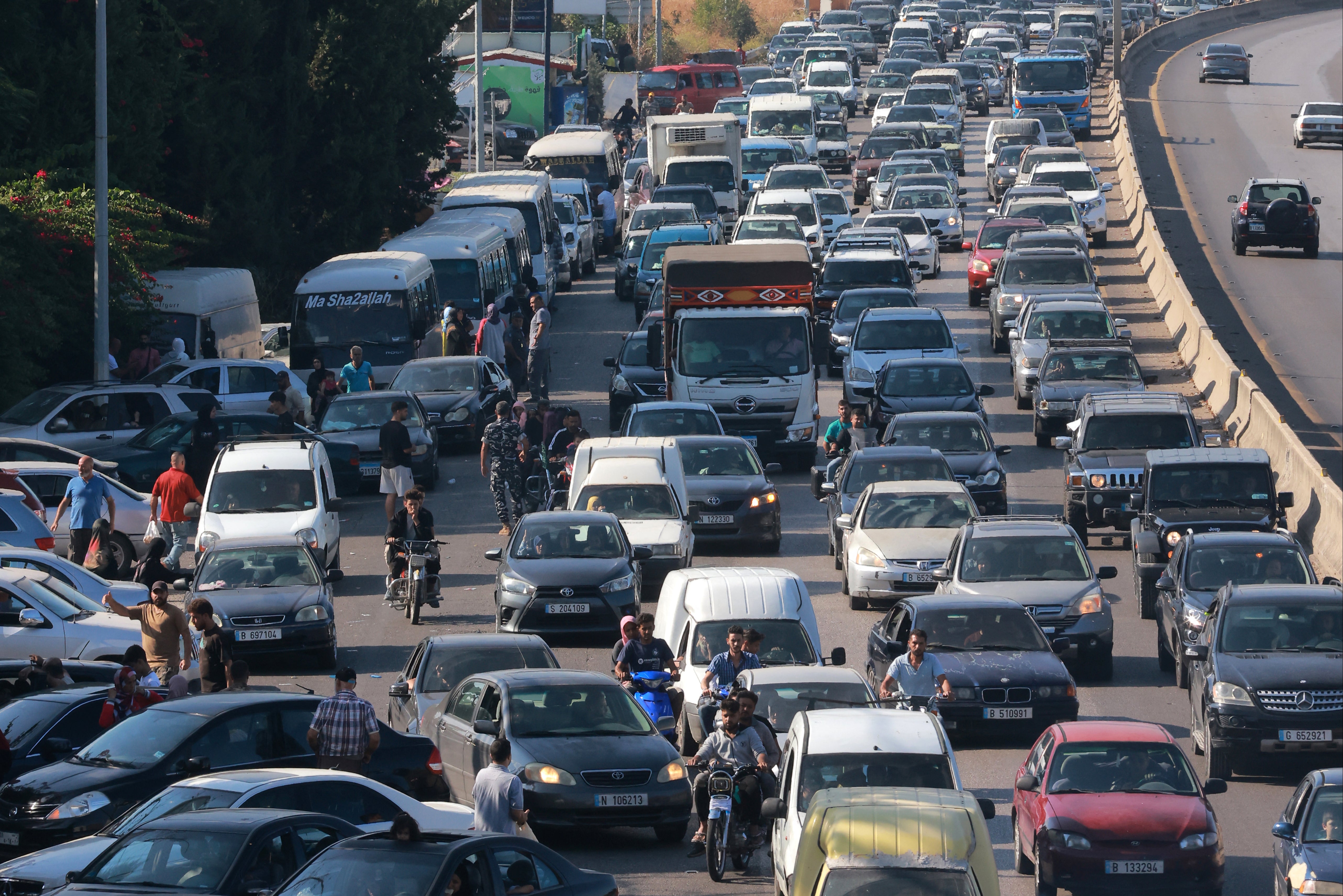 Vehicles wait in traffic in the town of Damour, south of the capital Beirut