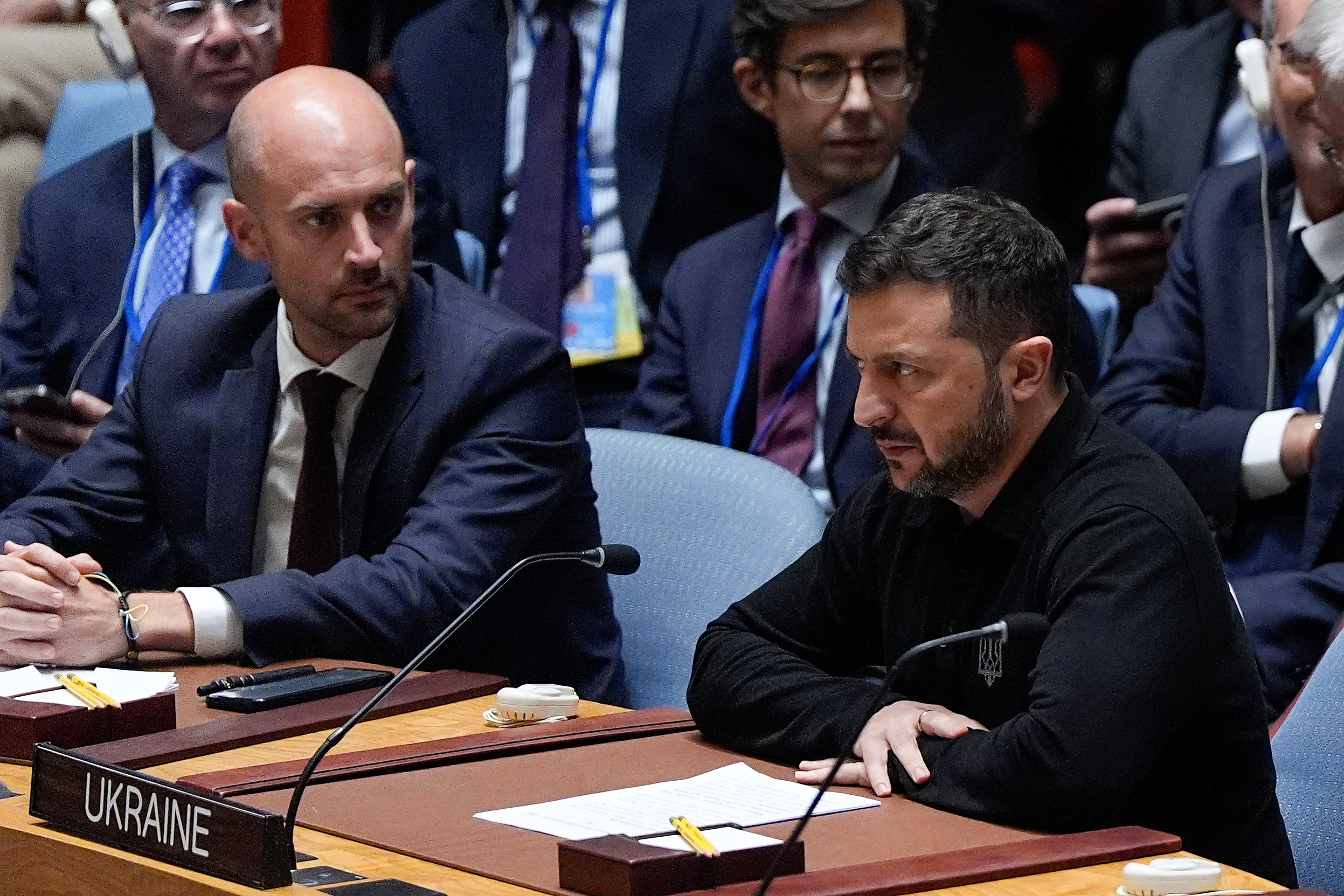 French foreign minister Jean-Noel Barrot (L) looks on as Volodymyr Zelensky speaks during a UN Security Council meeting