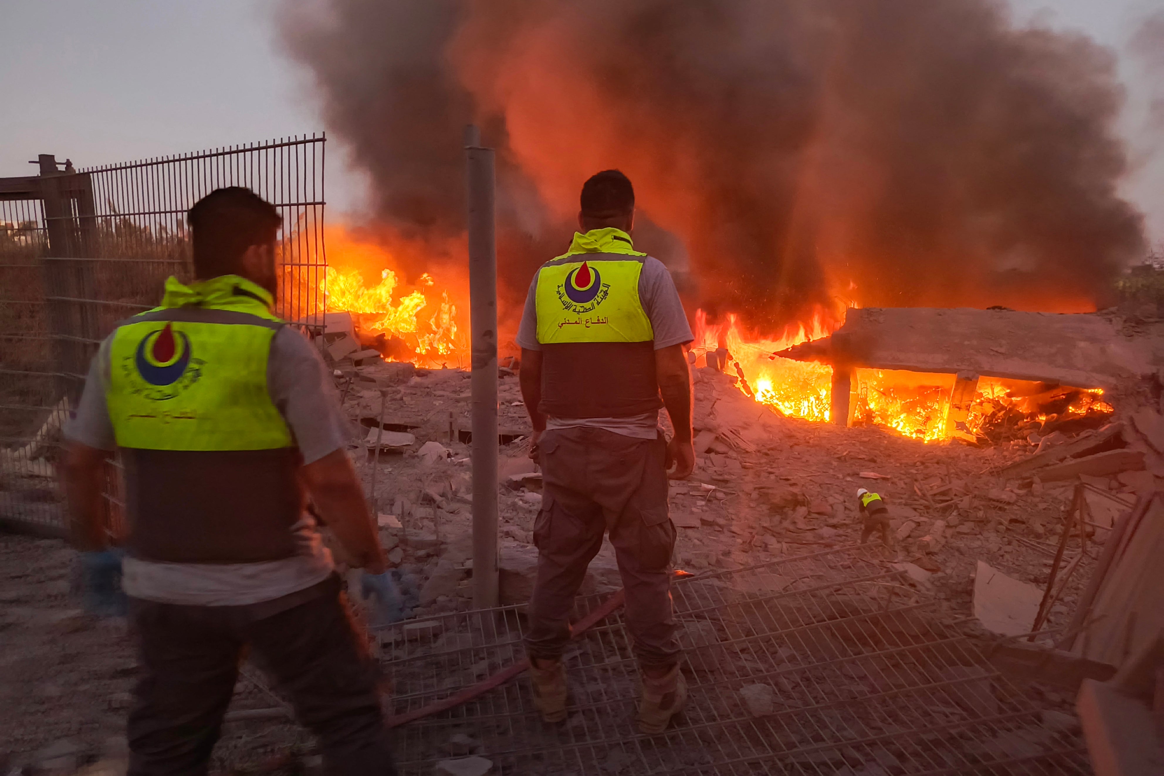 Rescuers rush to the scene of an Israeli airstrike that targeted the southern Lebanese village of Abbasiyeh