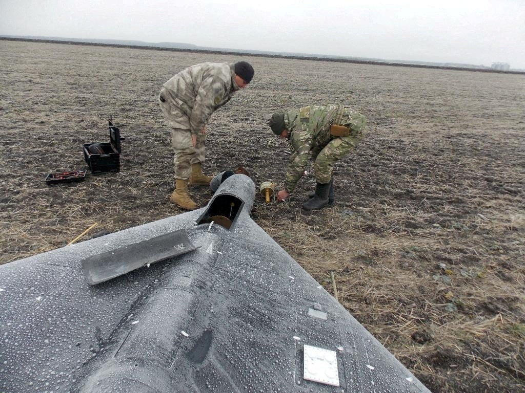 Ukrainian serviceman remove a warhead from a Russian kamikaze UAV