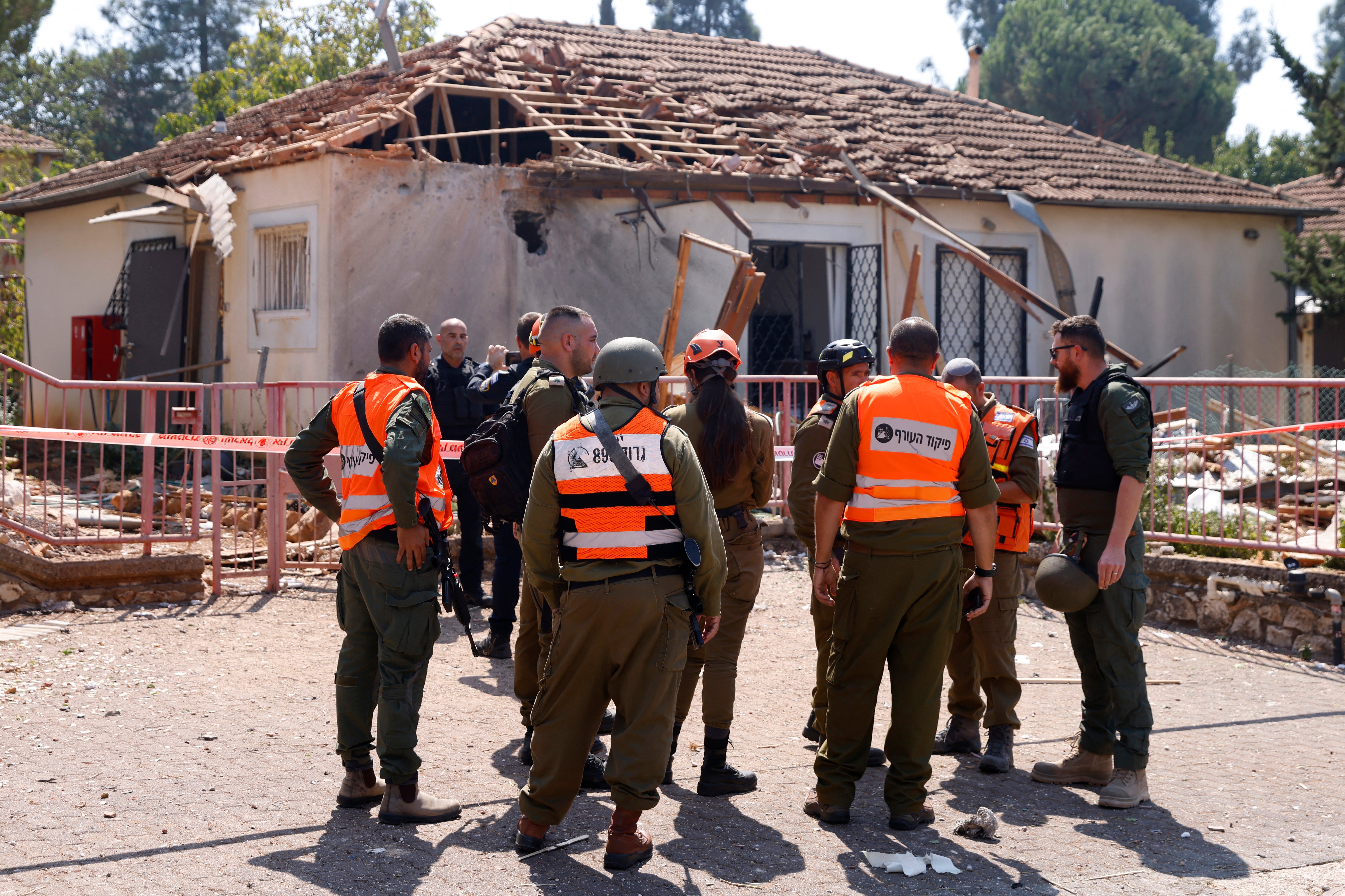 Israeli emergency responders arrive at the site of a rocket strike, fired from Lebanon, in the northern Israeli city of Safed