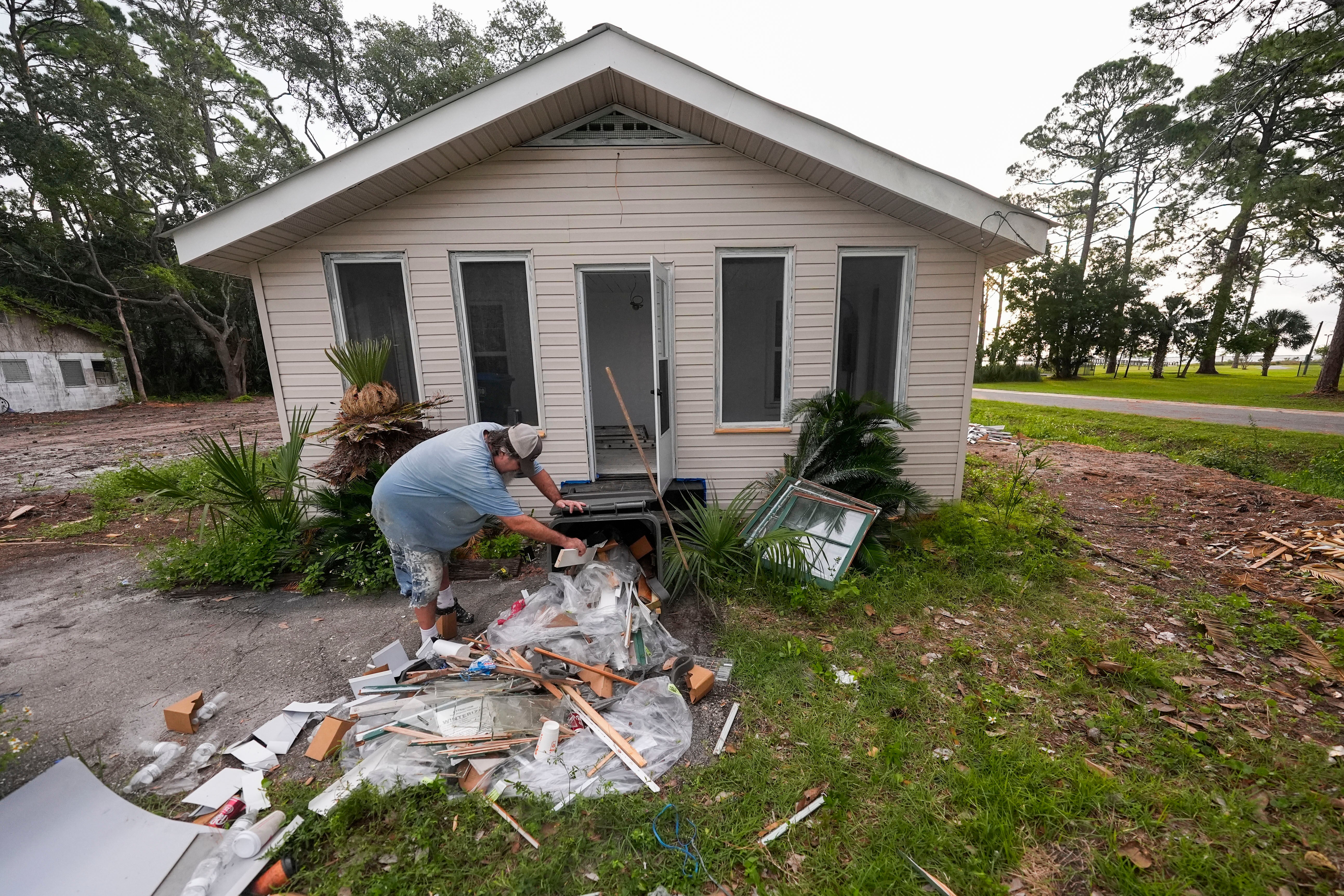 Panacea local cleans up remodeling debris in advance of Tropical Storm Helene making landfall on Thursday