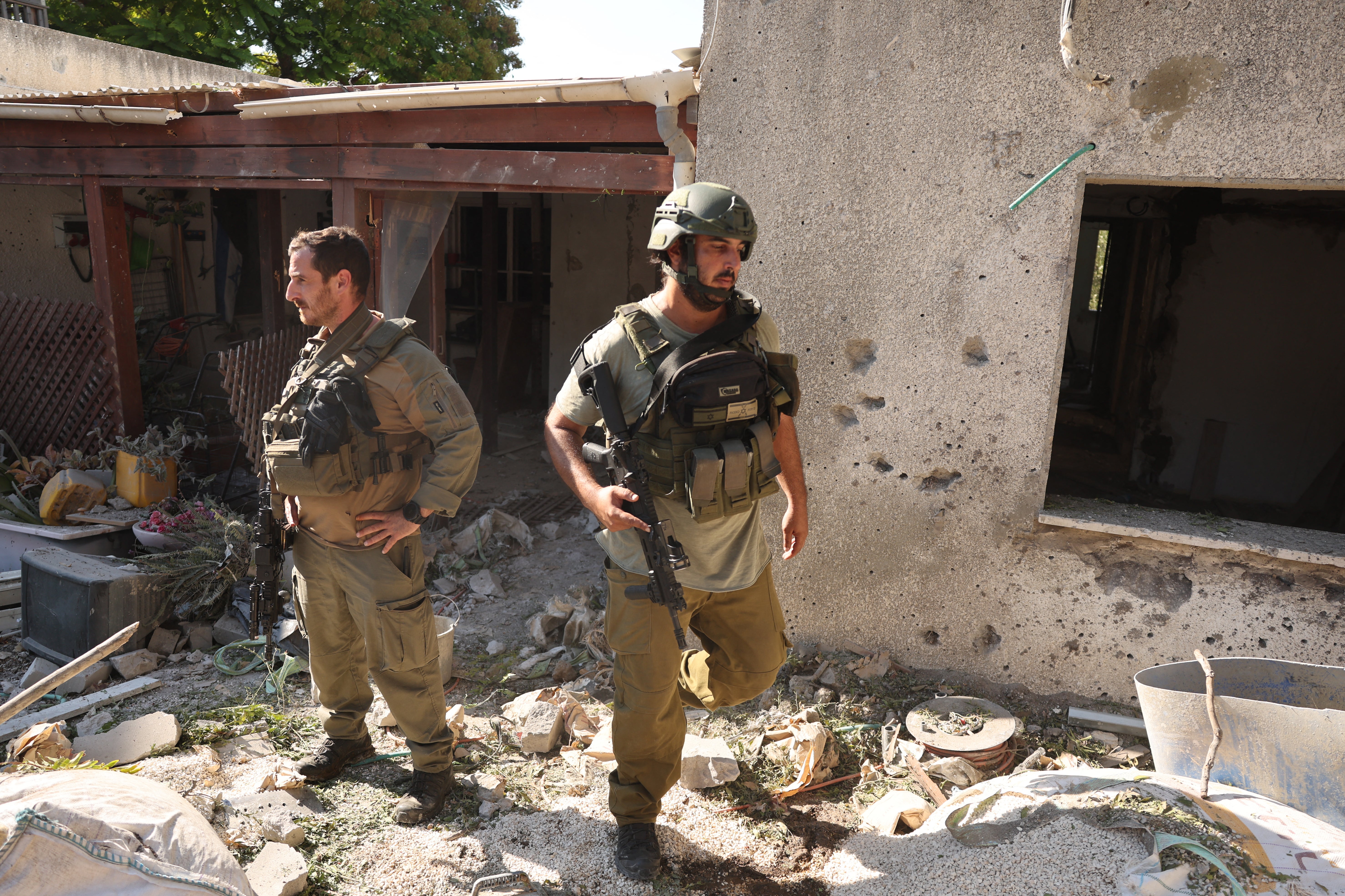 Israeli emergency responders inspect the site of a rocket attack, fired from Lebanon, in Kibbutz Saar, north of Nahariya