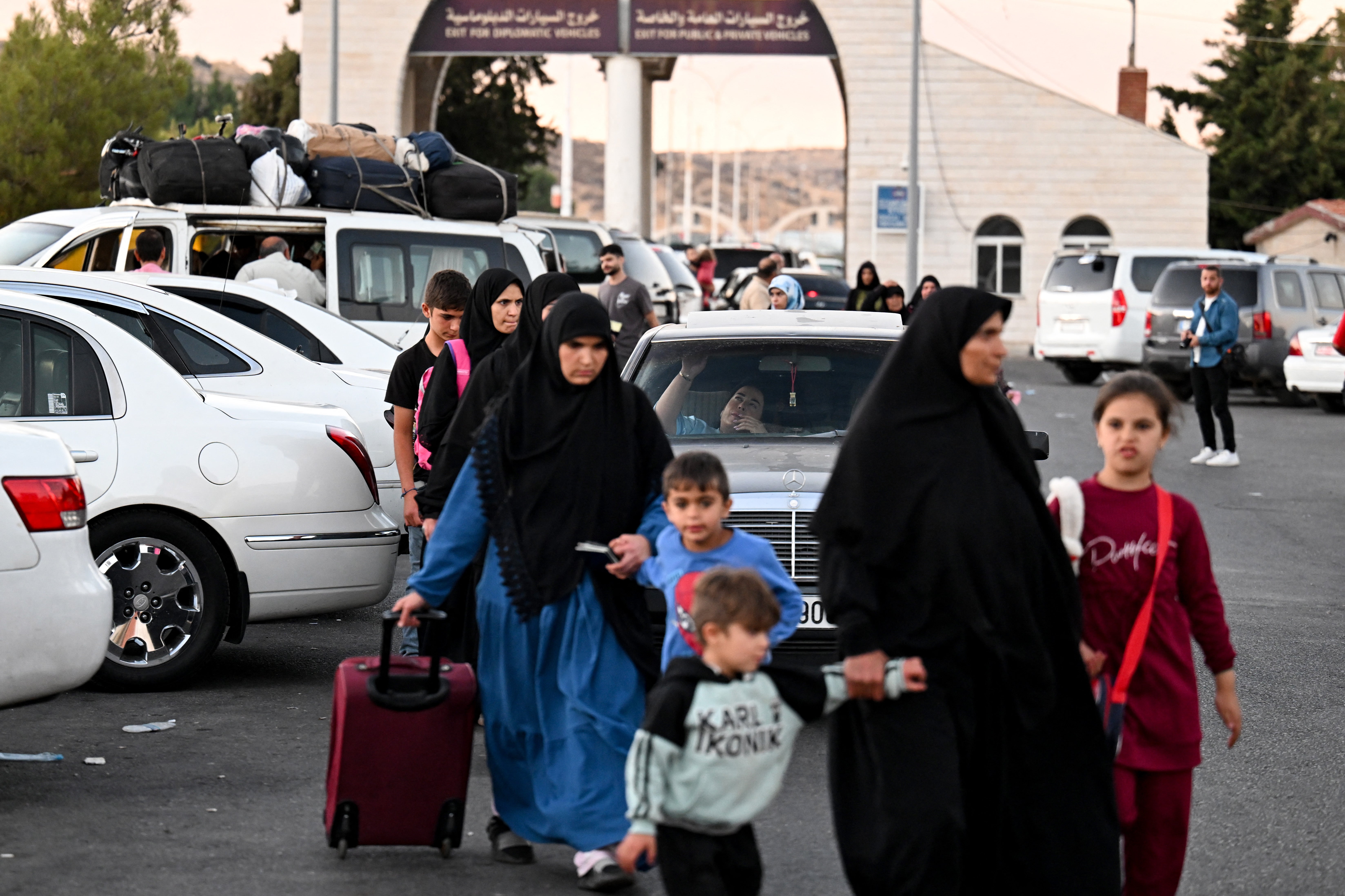 People fleeing from Lebanon arrive on the Syrian side of the border with Lebanon in Jdeidat Yabus in southwestern Syria