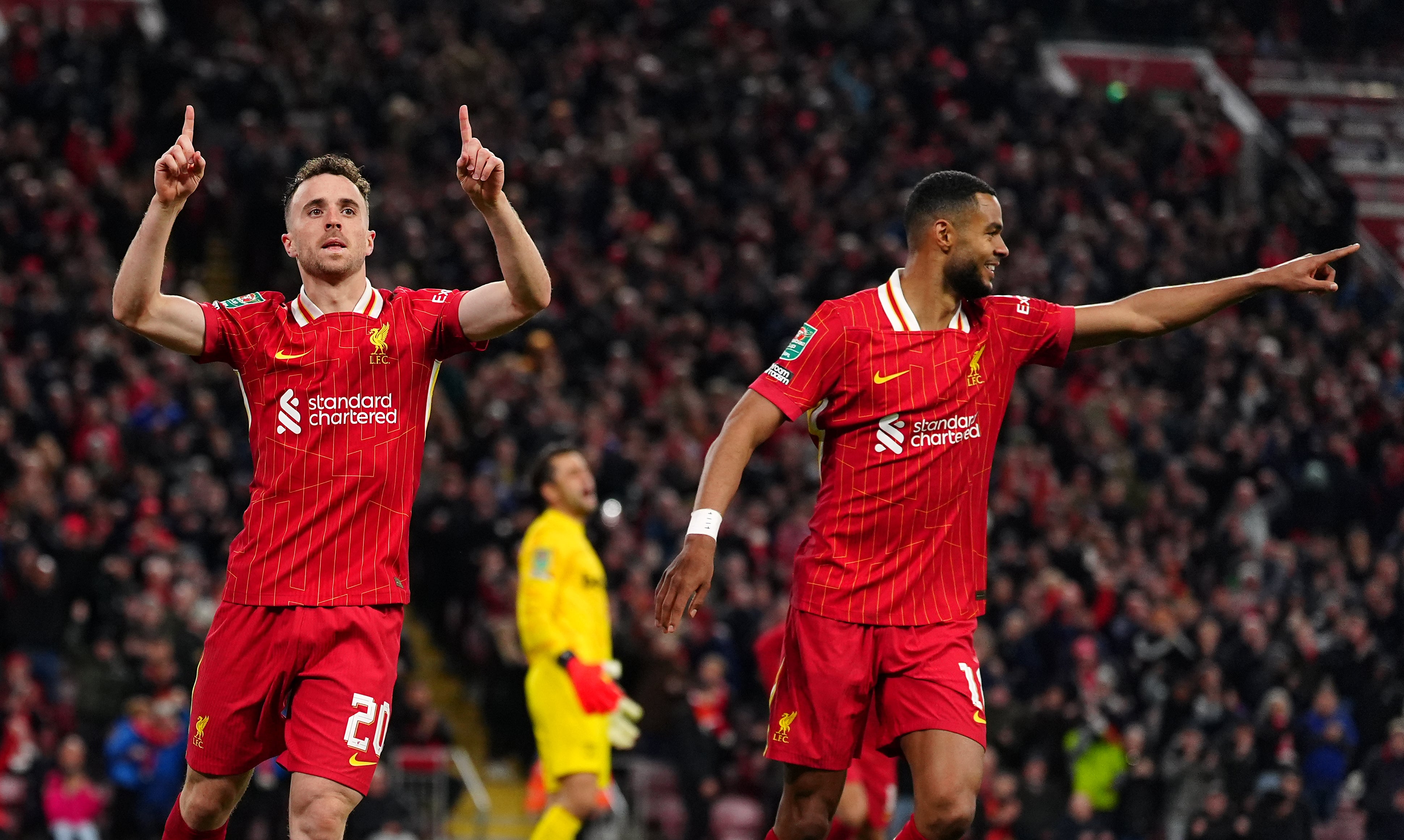 Diogo Jota, left, celebrates scoring Liverpool’s second goal with teammate Cody Gakpo