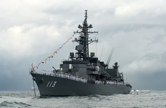 <p>Fine Crew members onboard Japan’s Navy Takanami class destroyers, JS Sazanami wave during the inaugural maritime review along the strait near Changi Naval Base in Singapore in 2017</p>