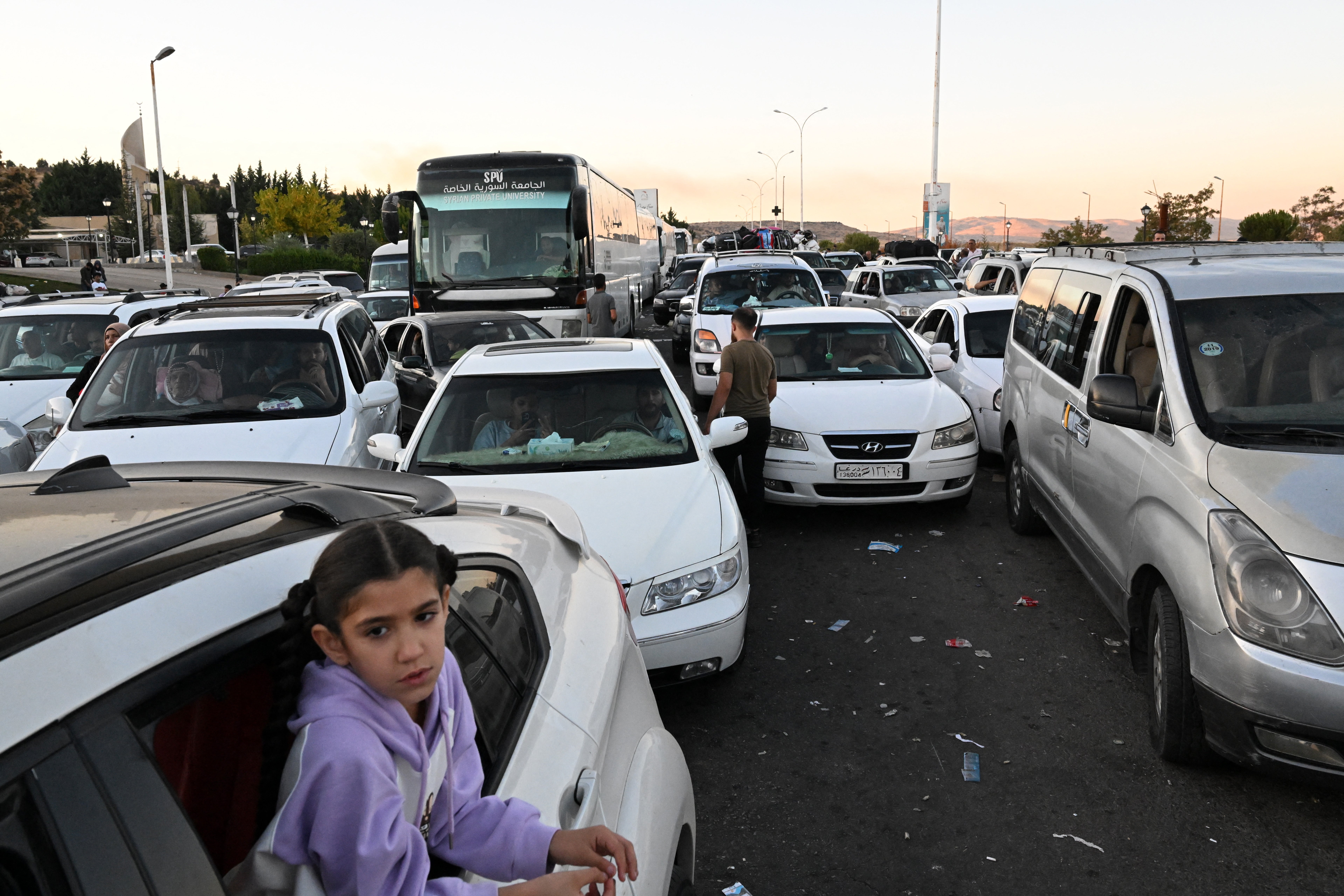 People fleeing from Lebanon arrive on the Syrian side of the border with Lebanon in Jdeidat Yabus