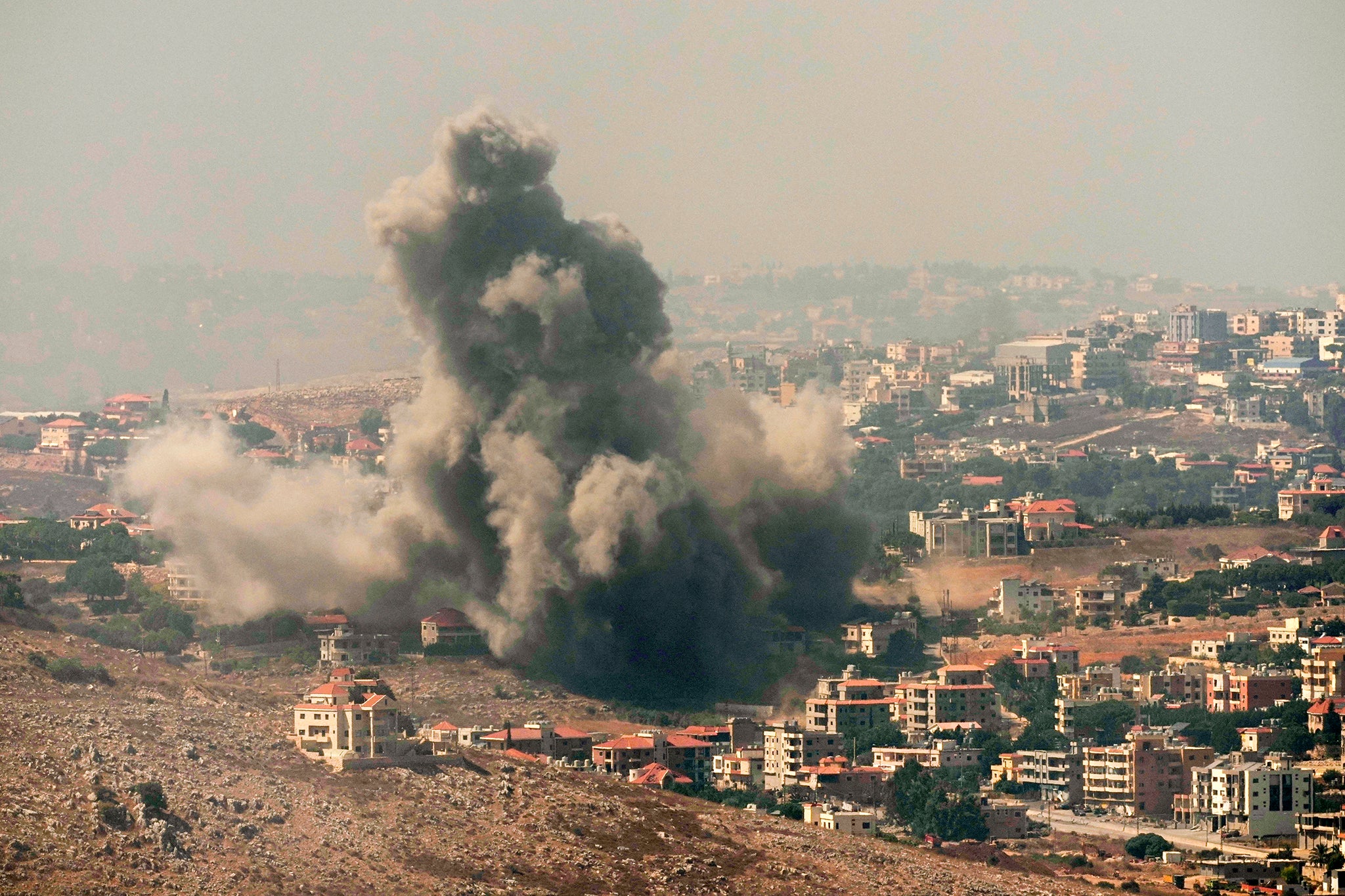 Smoke rises from an Israeli airstrike in the southern village of Kfar Rouman